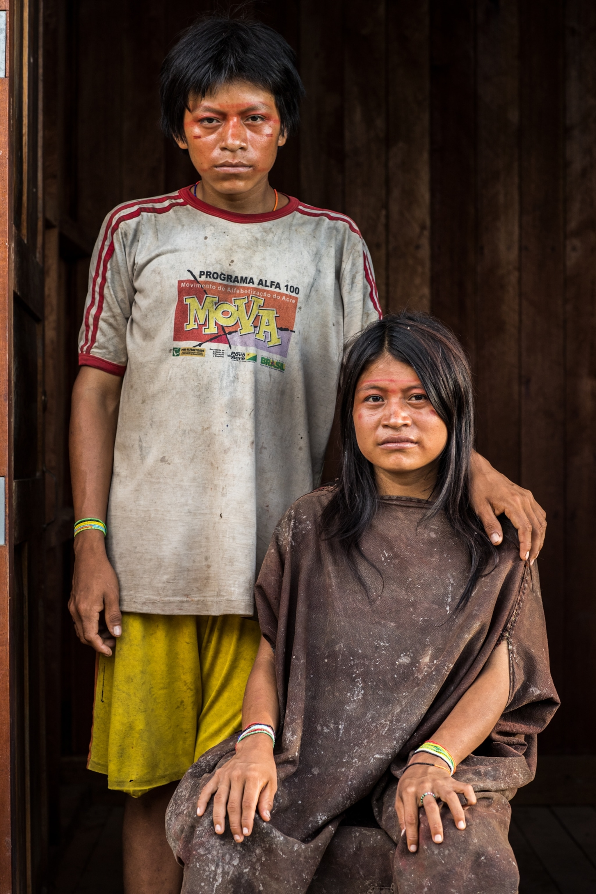 of a teen boy and girl sitting and standing for portrait