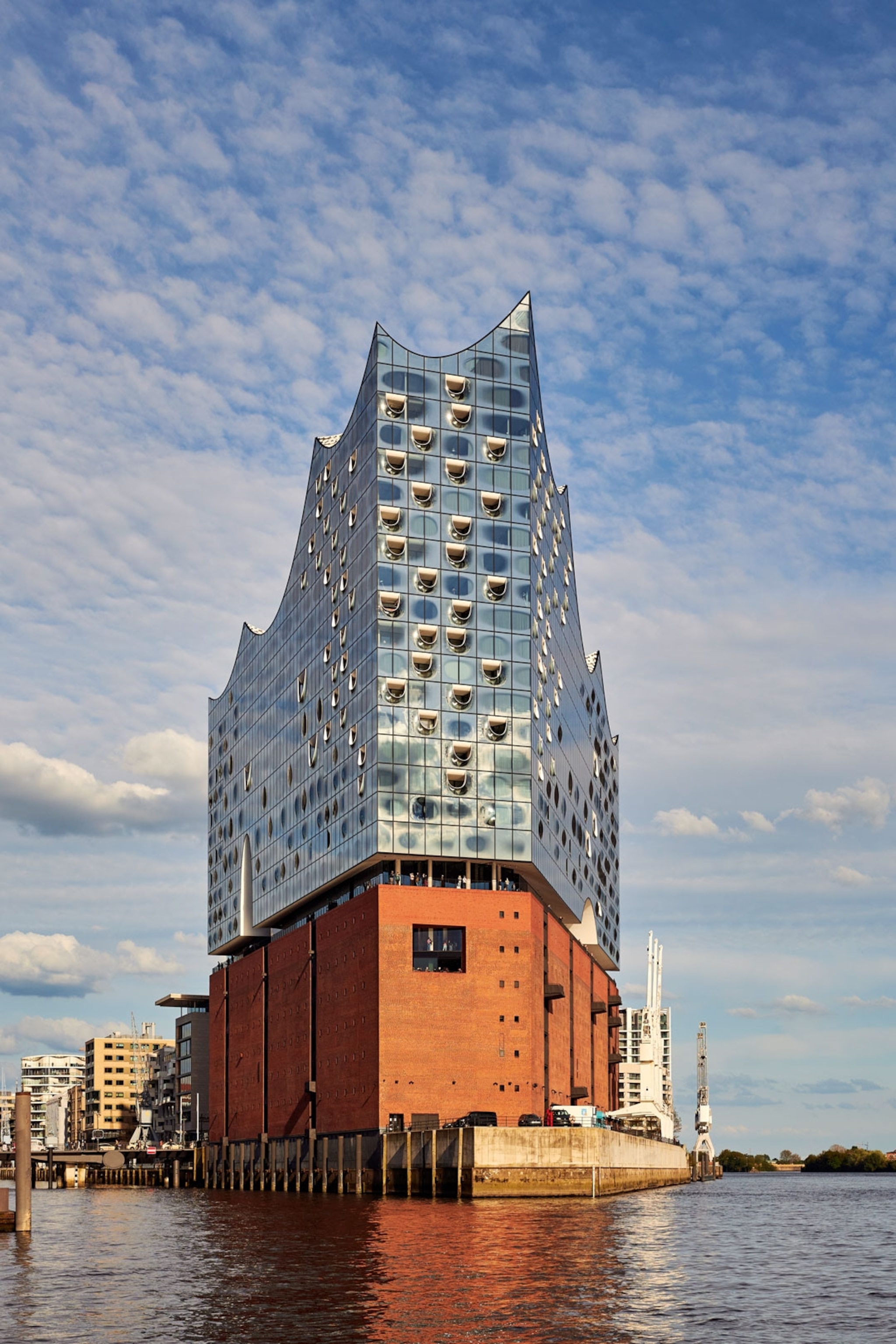 Futuristic building sits in the middle of a river.