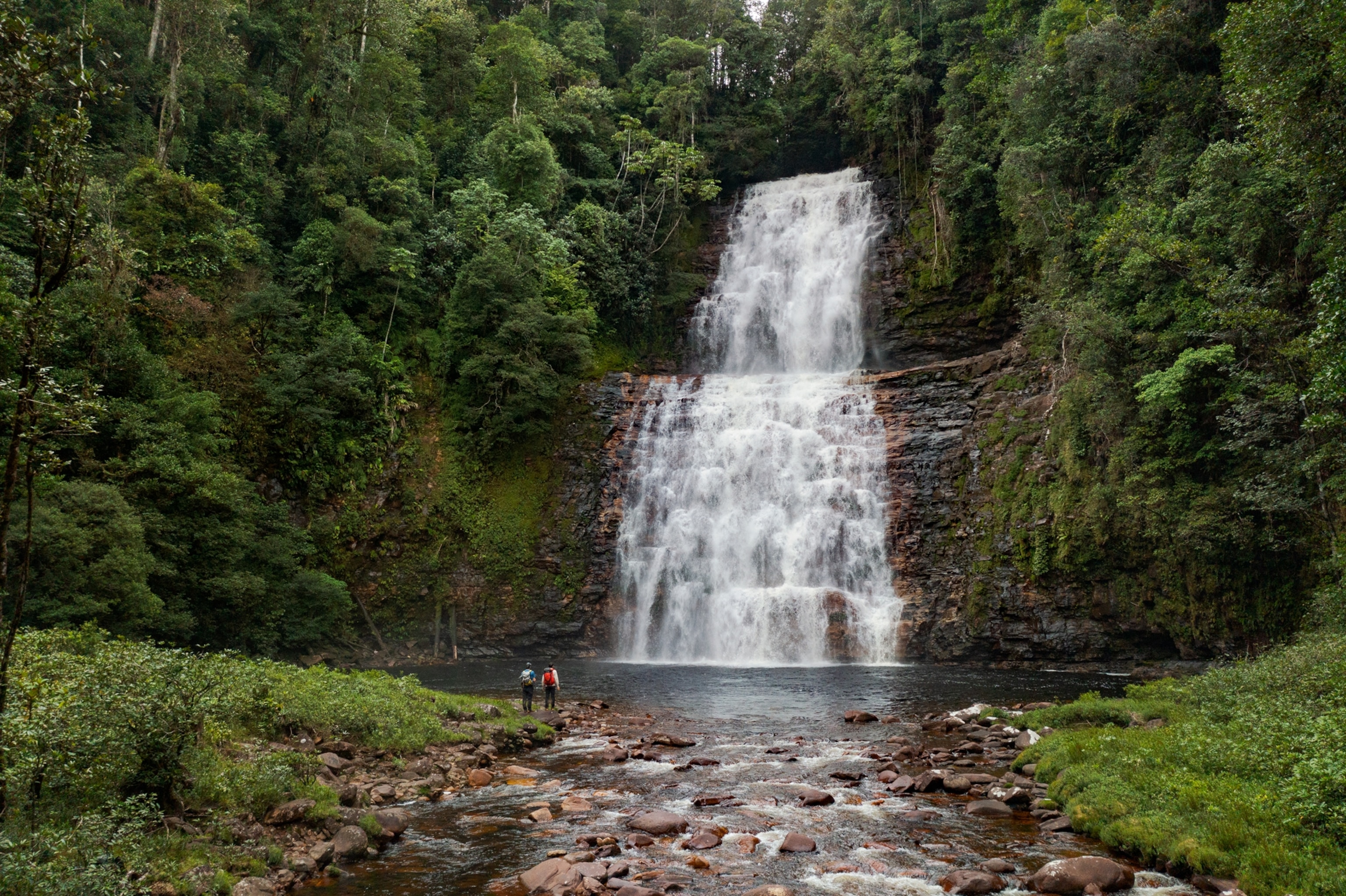 Picture of two people looking at cascading water fall.