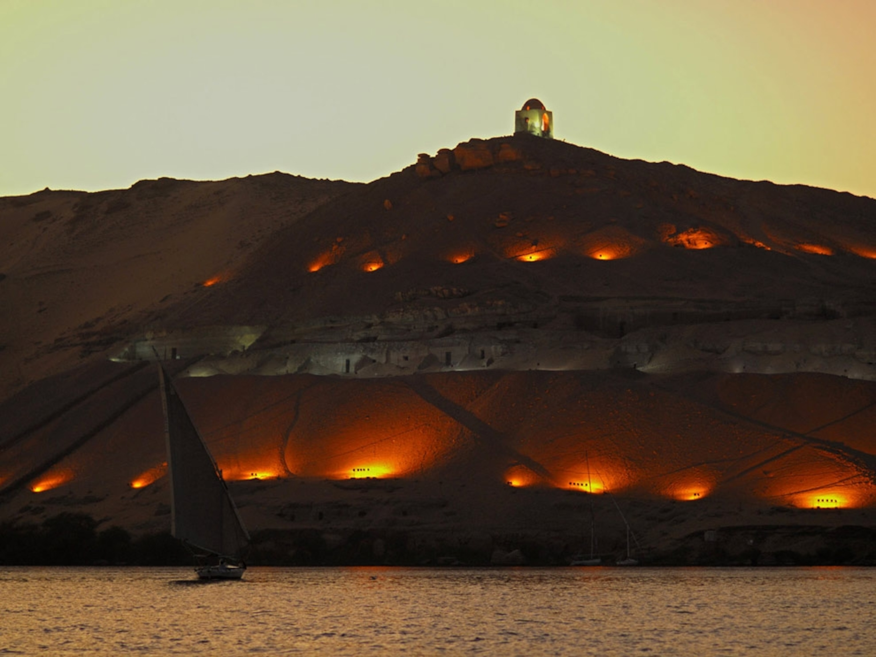 Illuminated tombs on riverbank