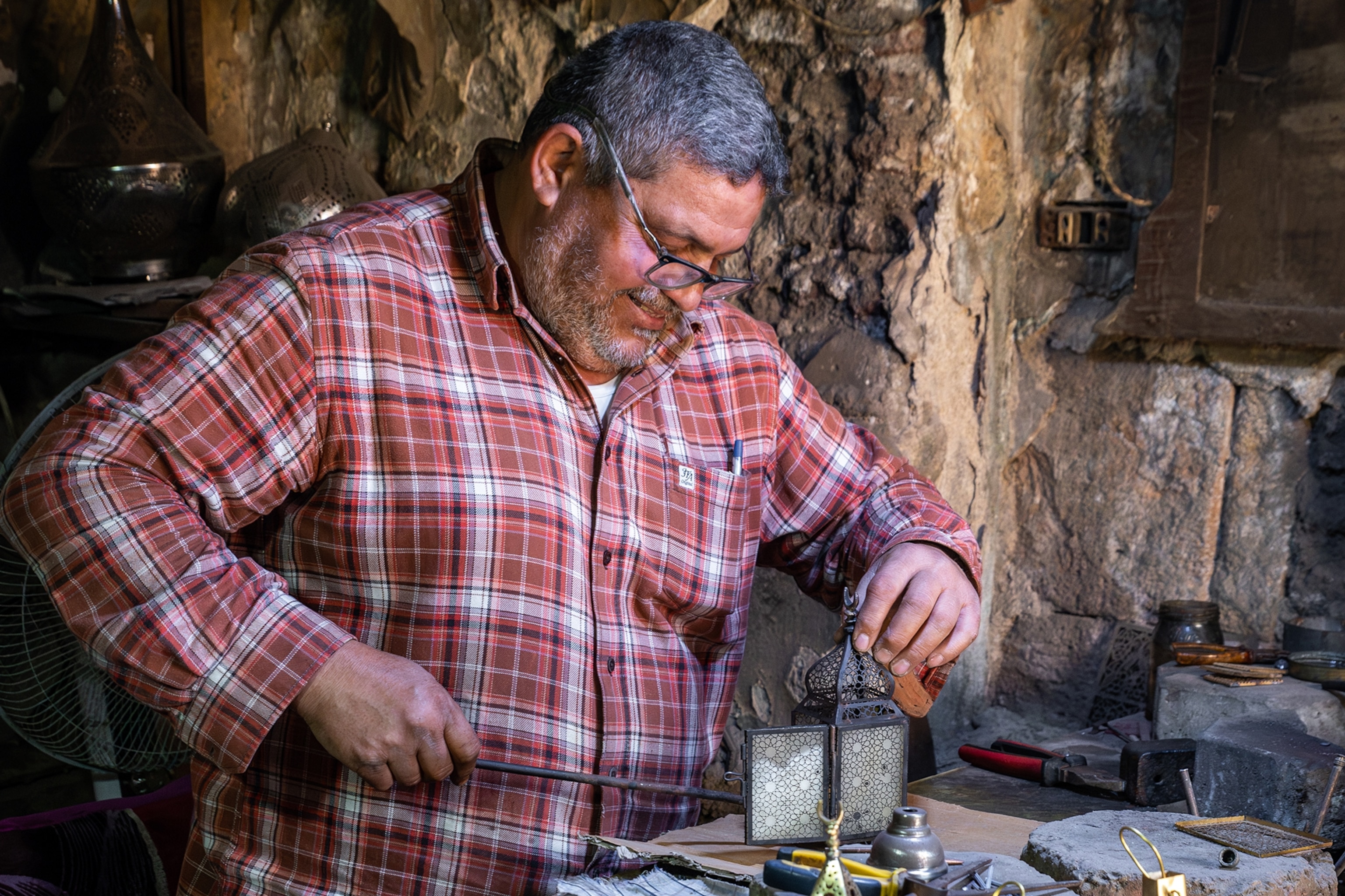 a man repairing lanterns
