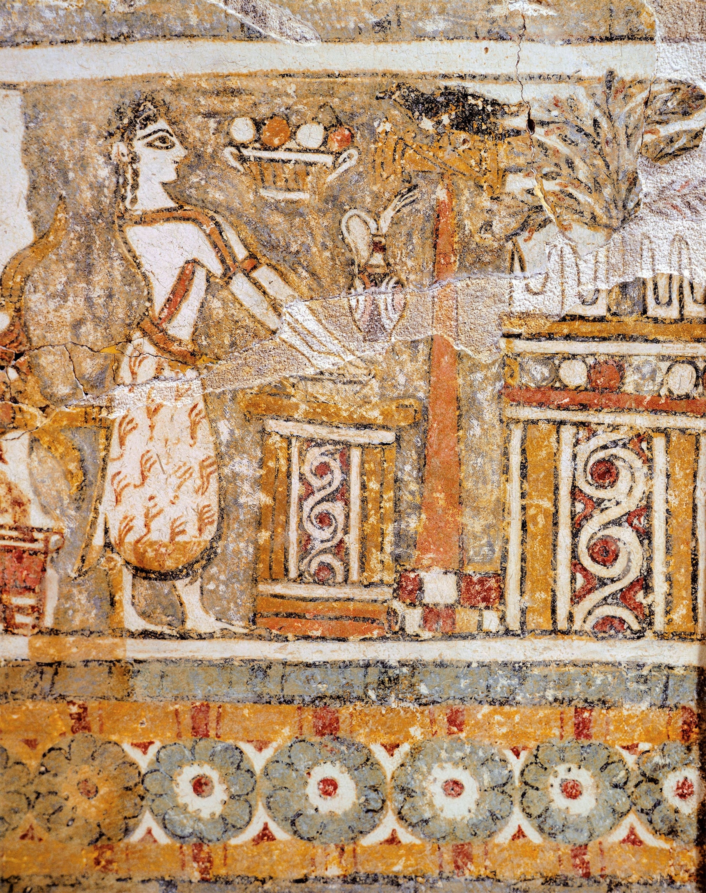 A detail from a limestone sarcophagus is painted with a scene of a person facing sideways