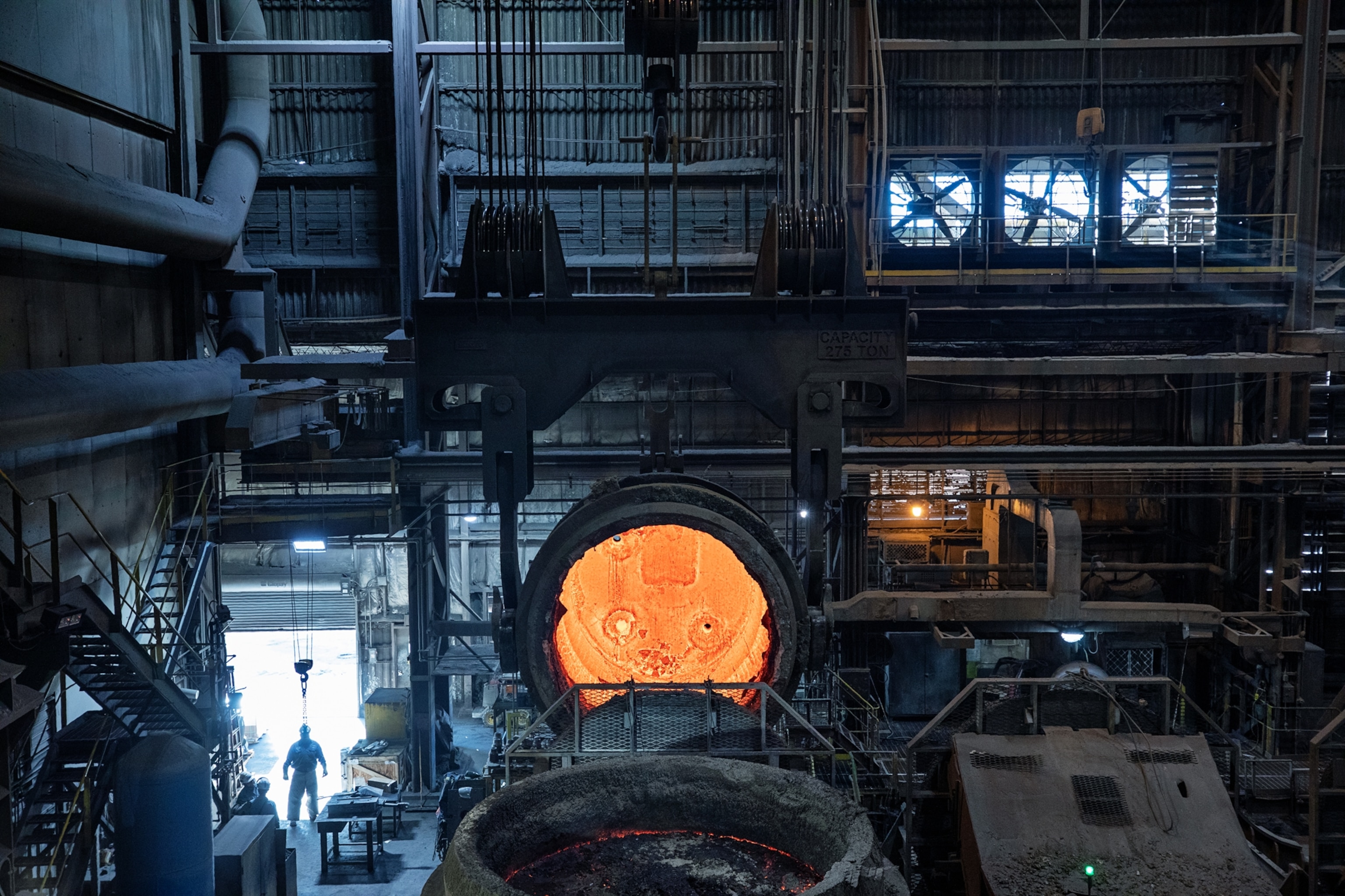 golden flame in opened furnaces in factory darkness.