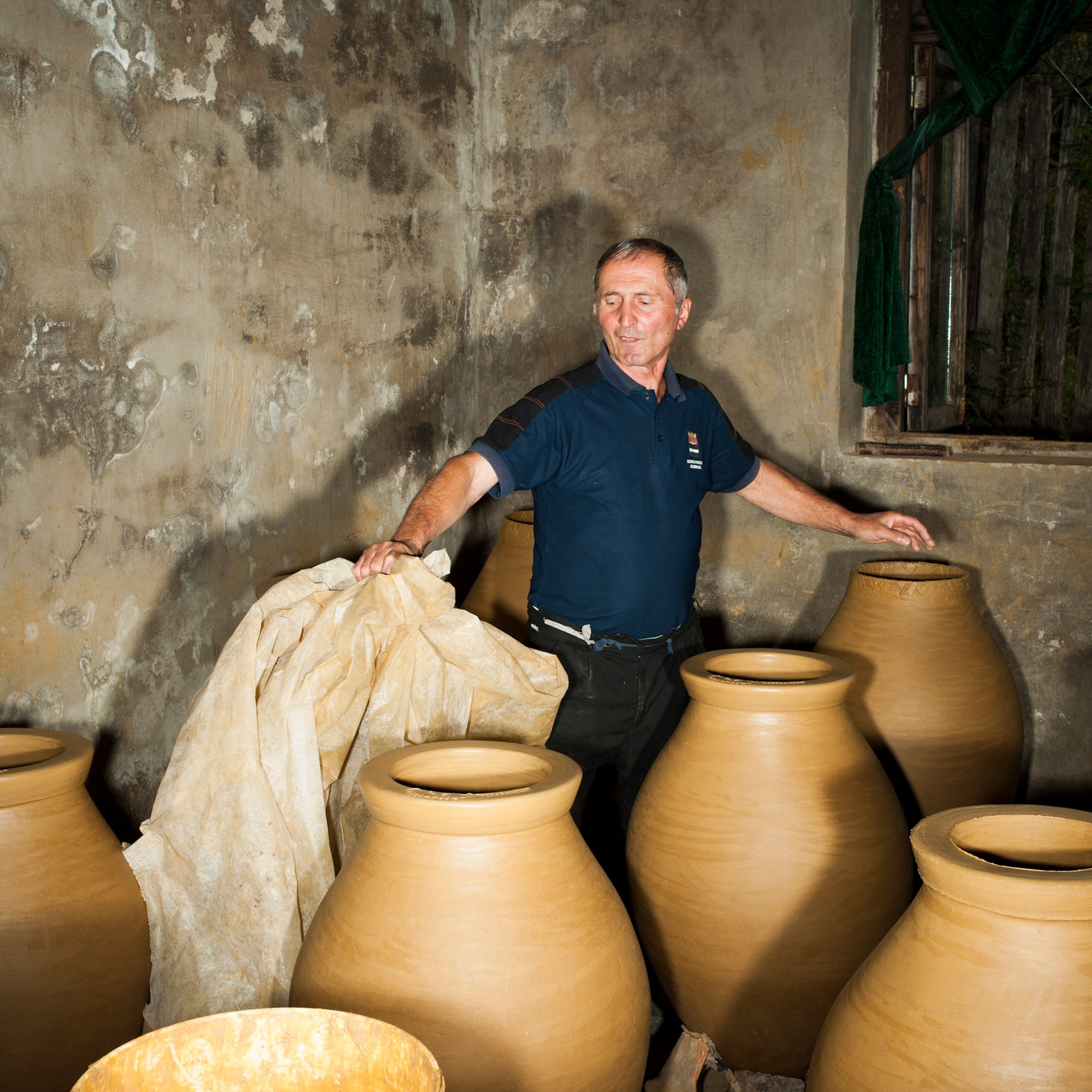 Large clay jars in a room.