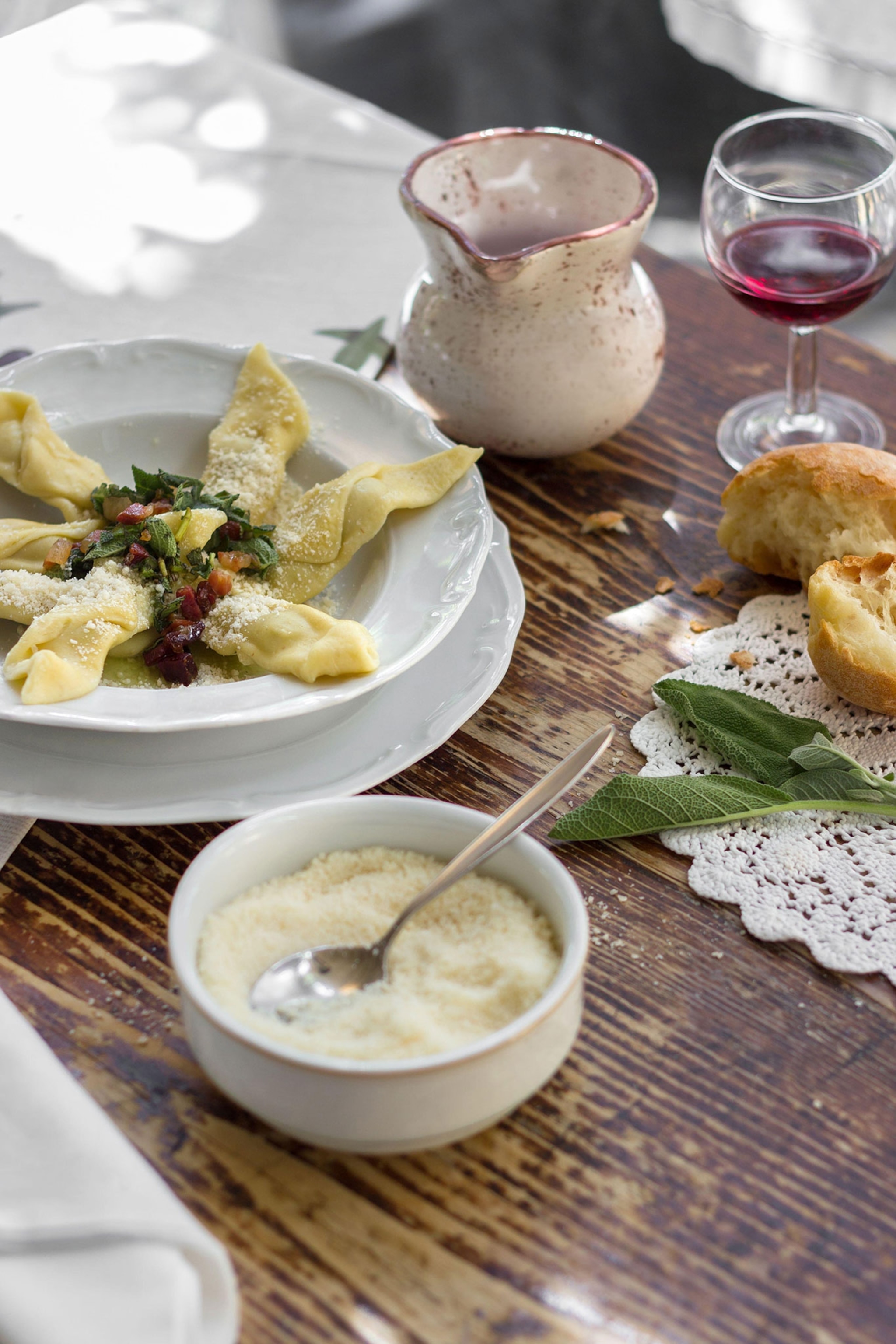 A wooden table filled with typical Italian cuisine.
