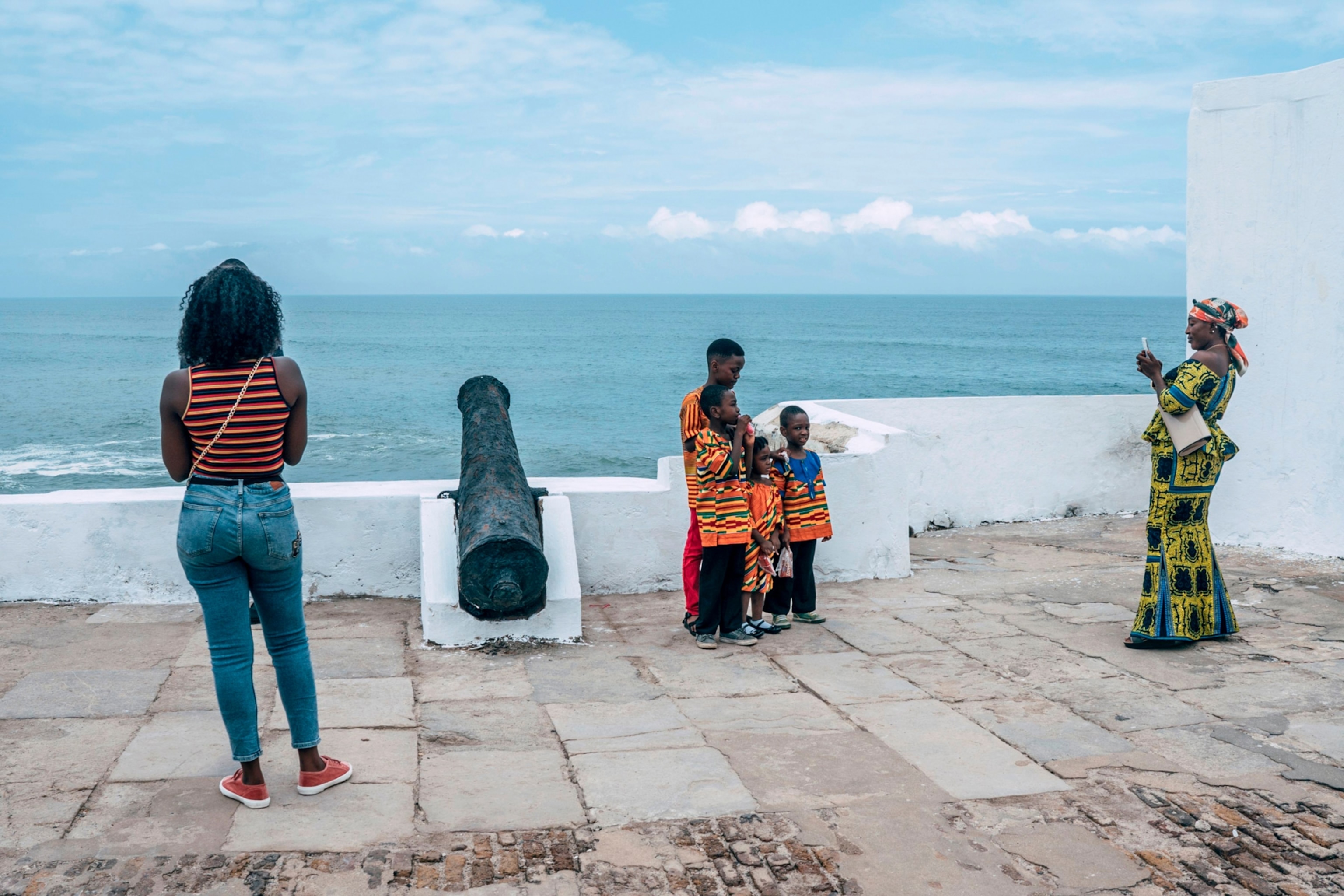 tourists posing for pictures at the Cape Coast Castle in Ghana