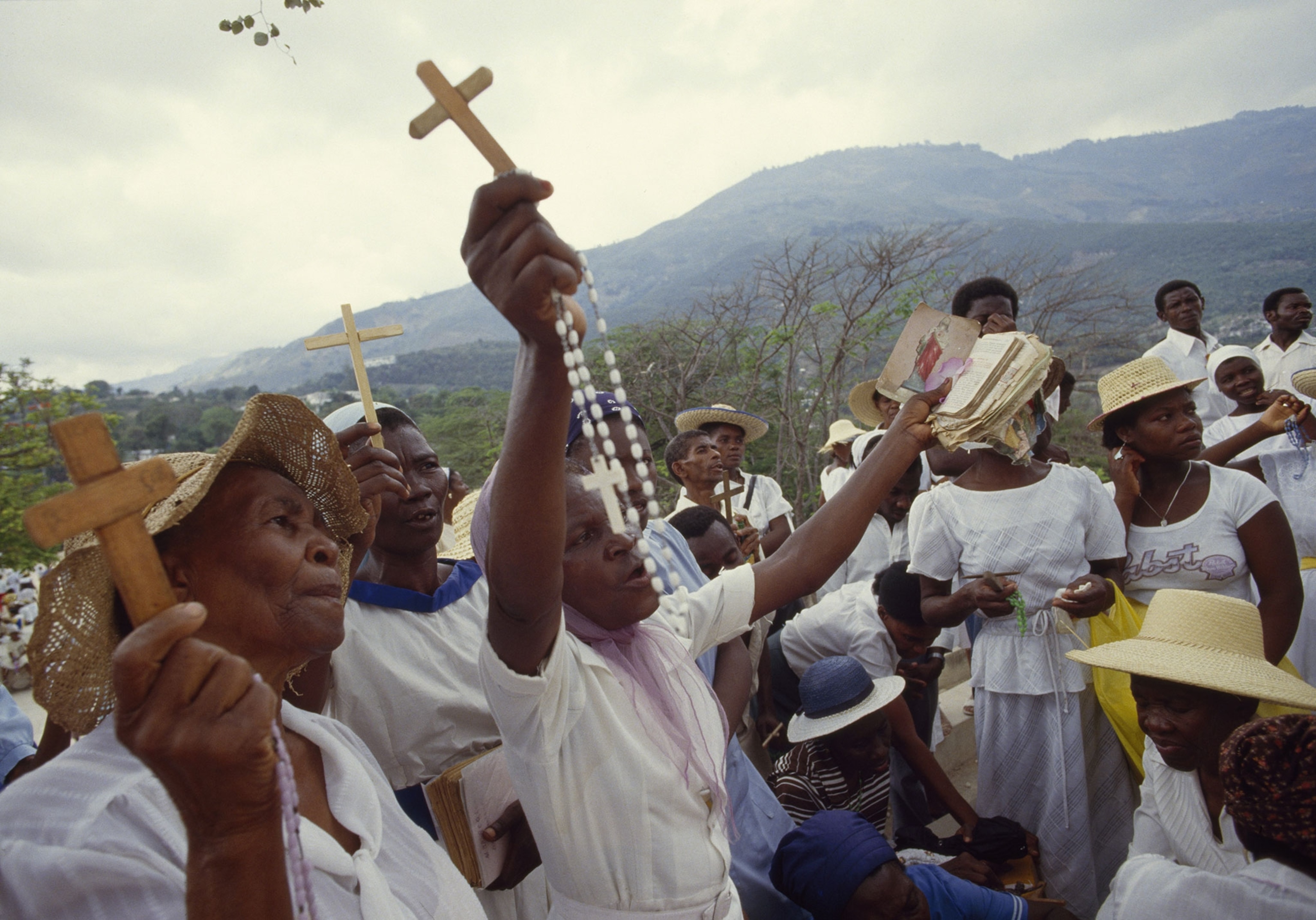 people outdoors holding crosses