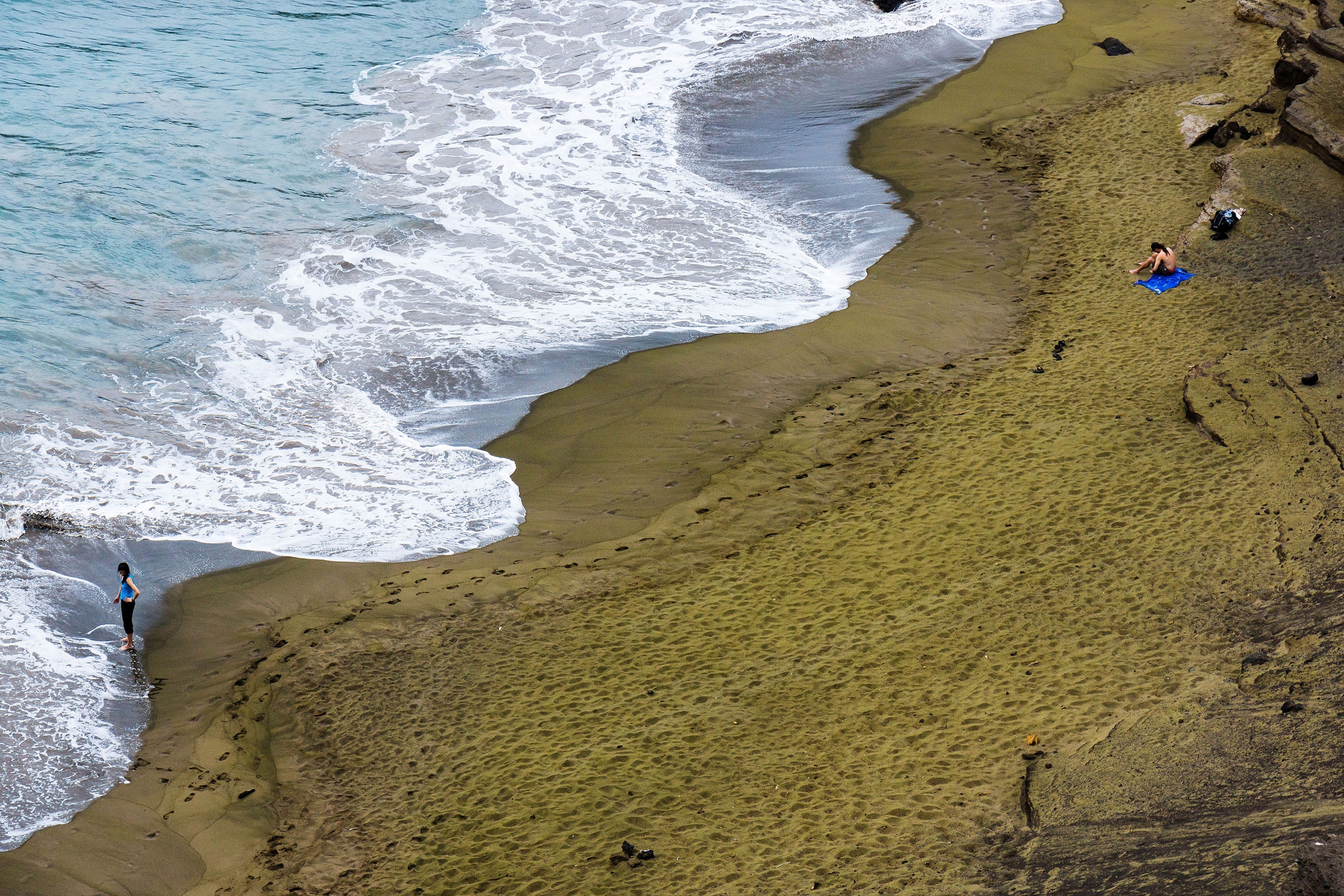 people on the green sands of Papakolea Beach in Hawaii
