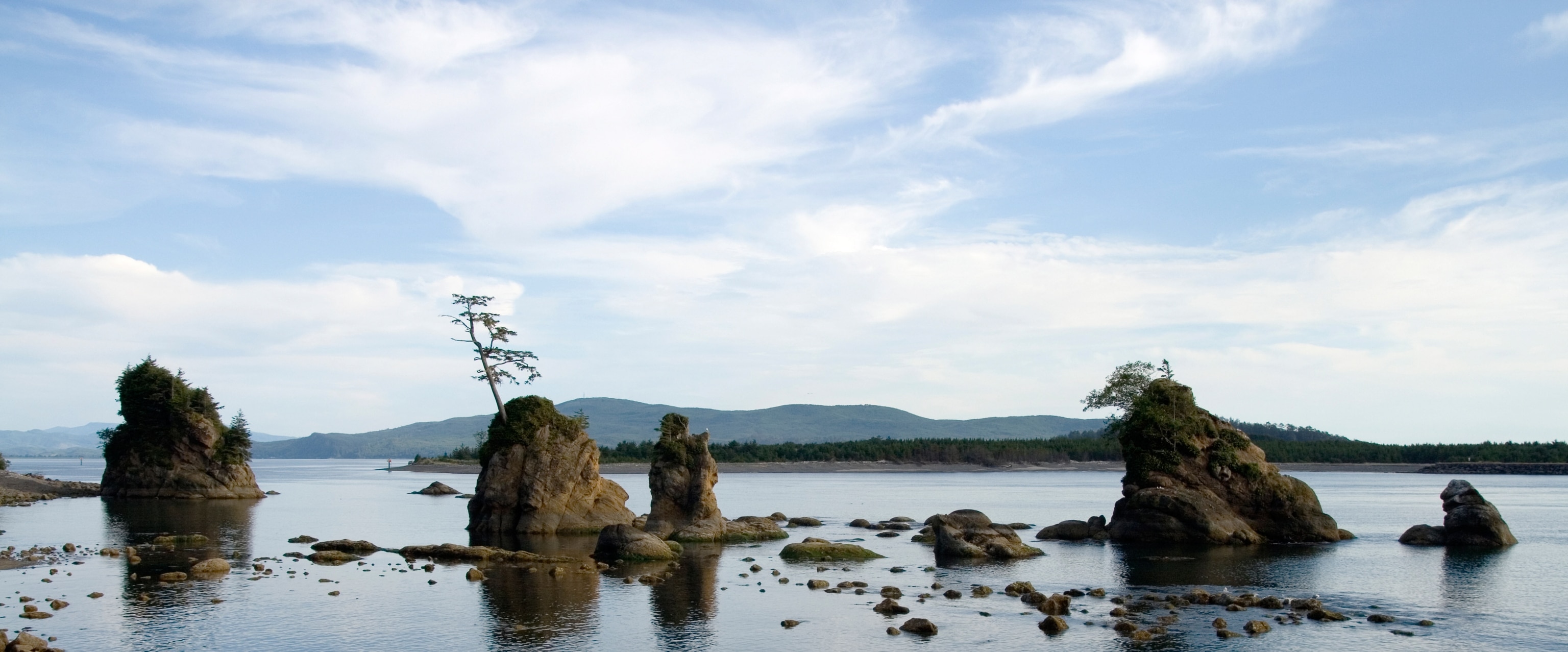 A series of small islands and rocks just off the shore