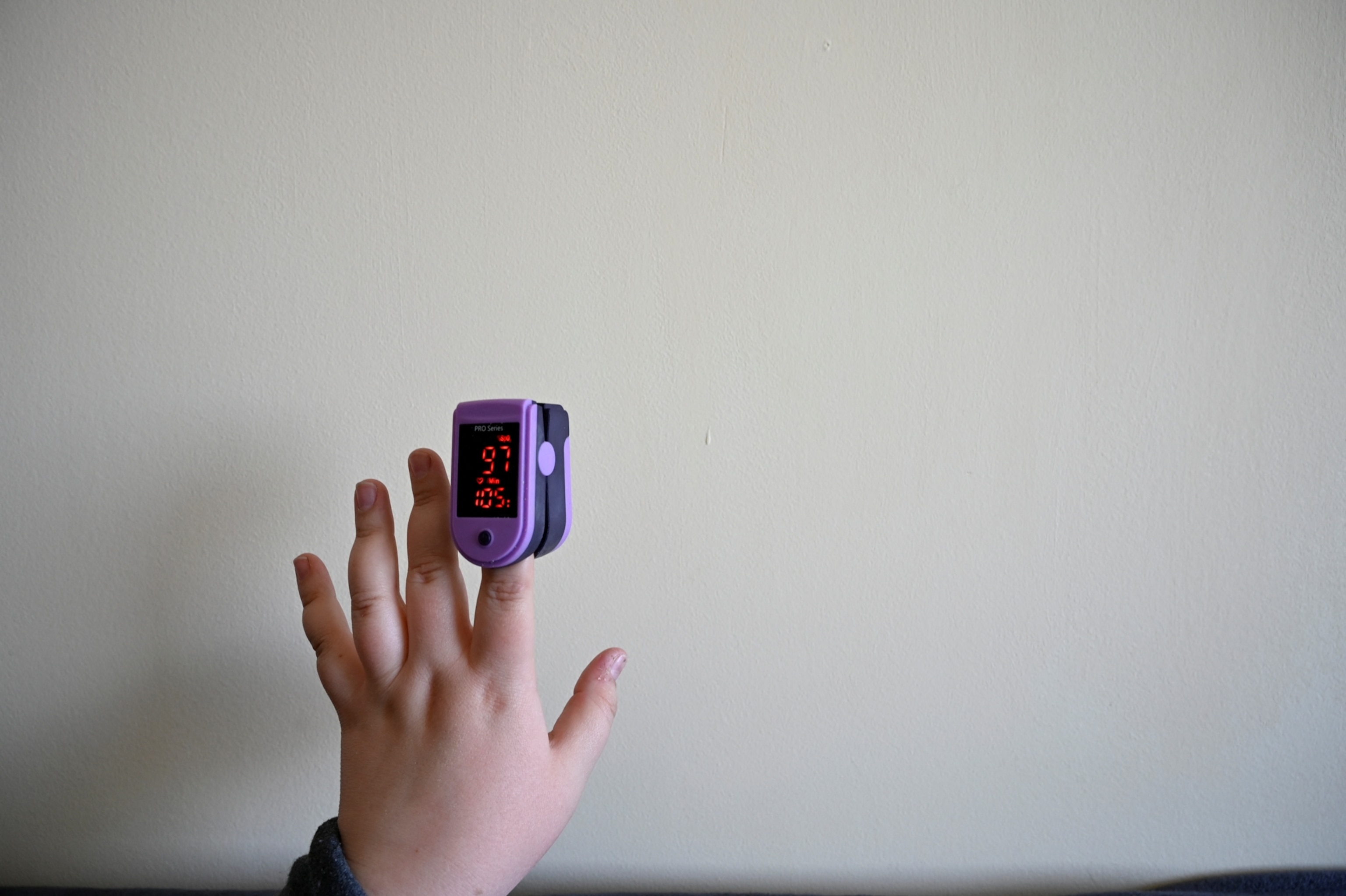 A pulse oximeter displaying someone's heart rate.