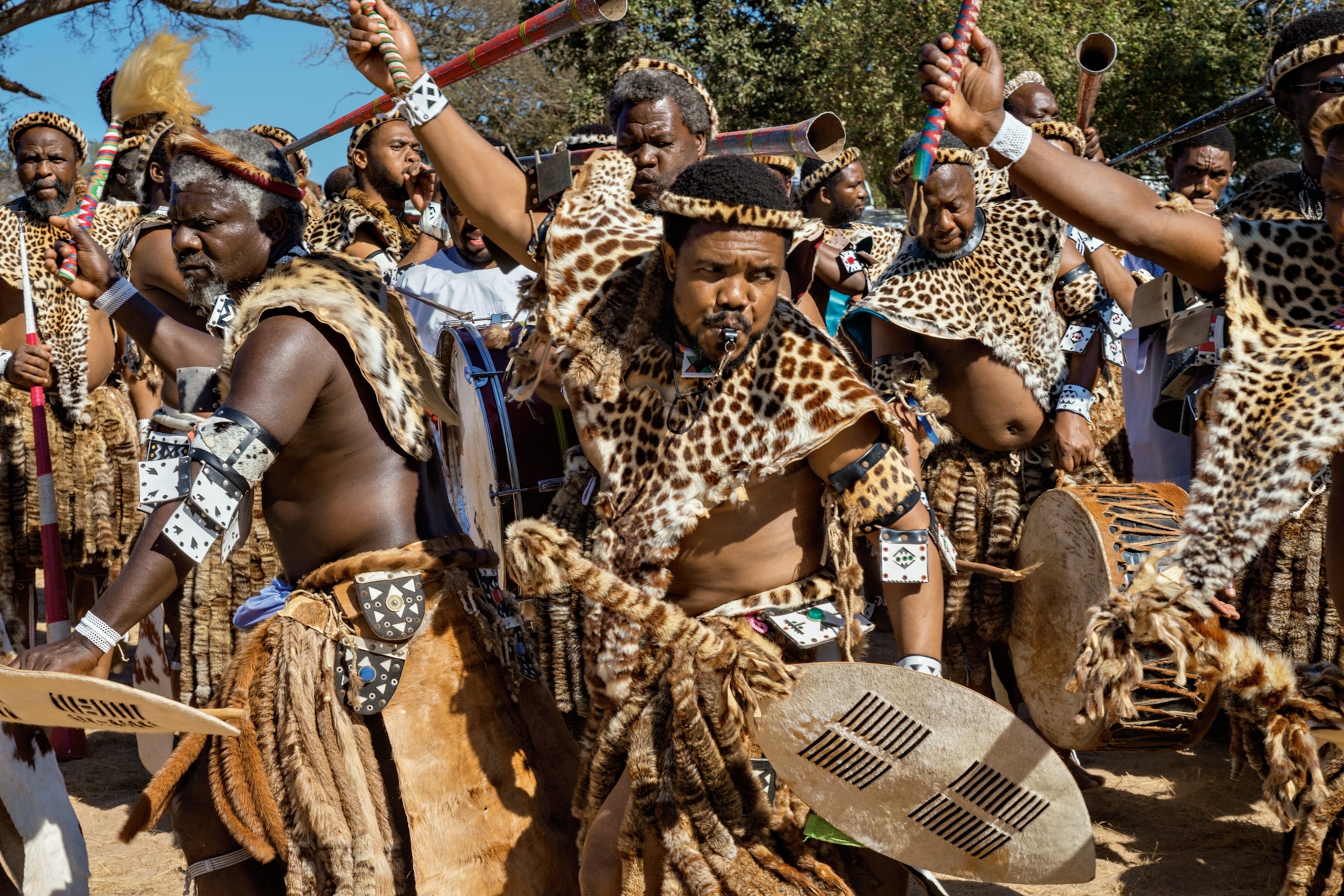 men adorned with leopard pelts performing a ritual in South Africa