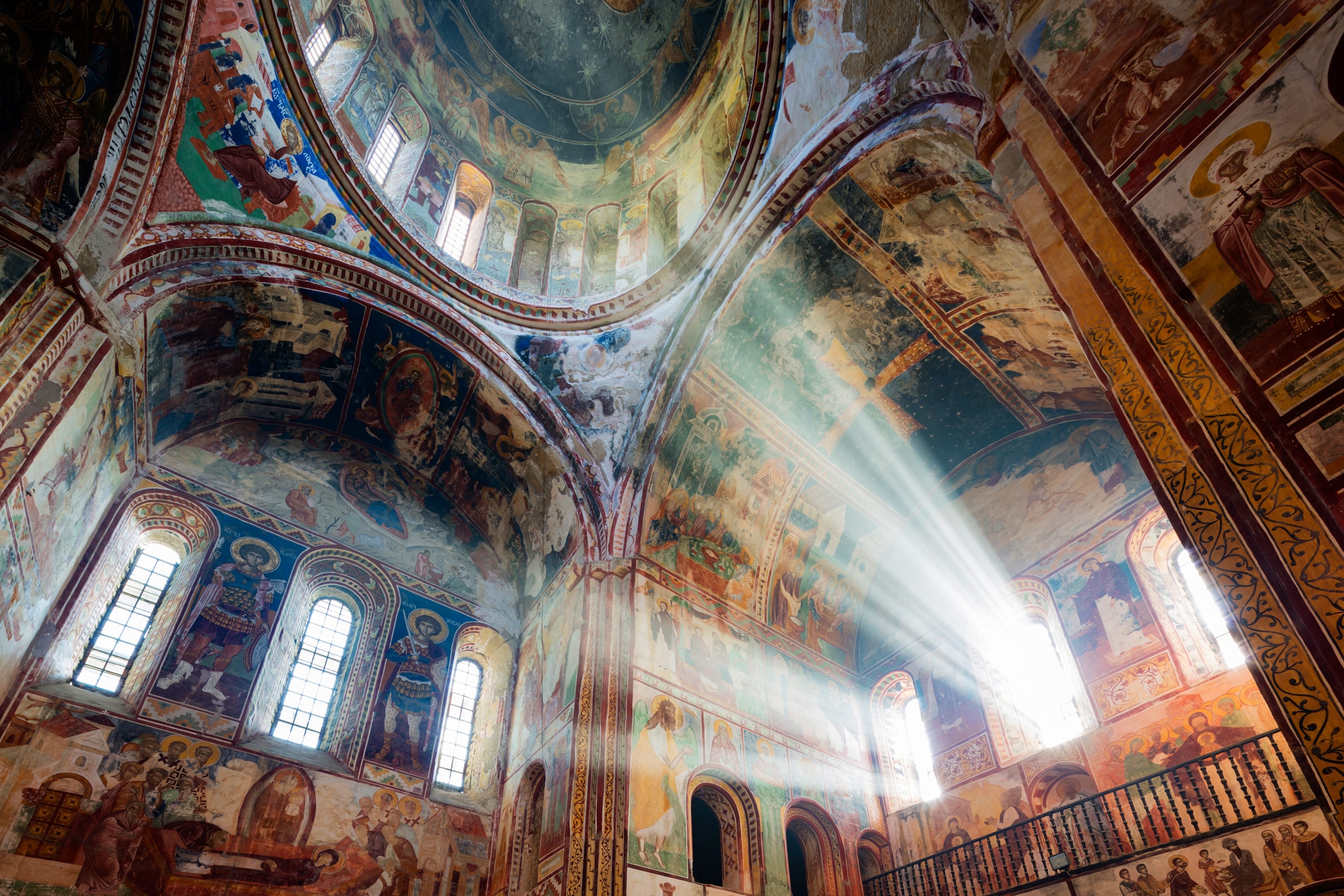 sunbeams shining through the ornate Gelati Monastery in Georgia