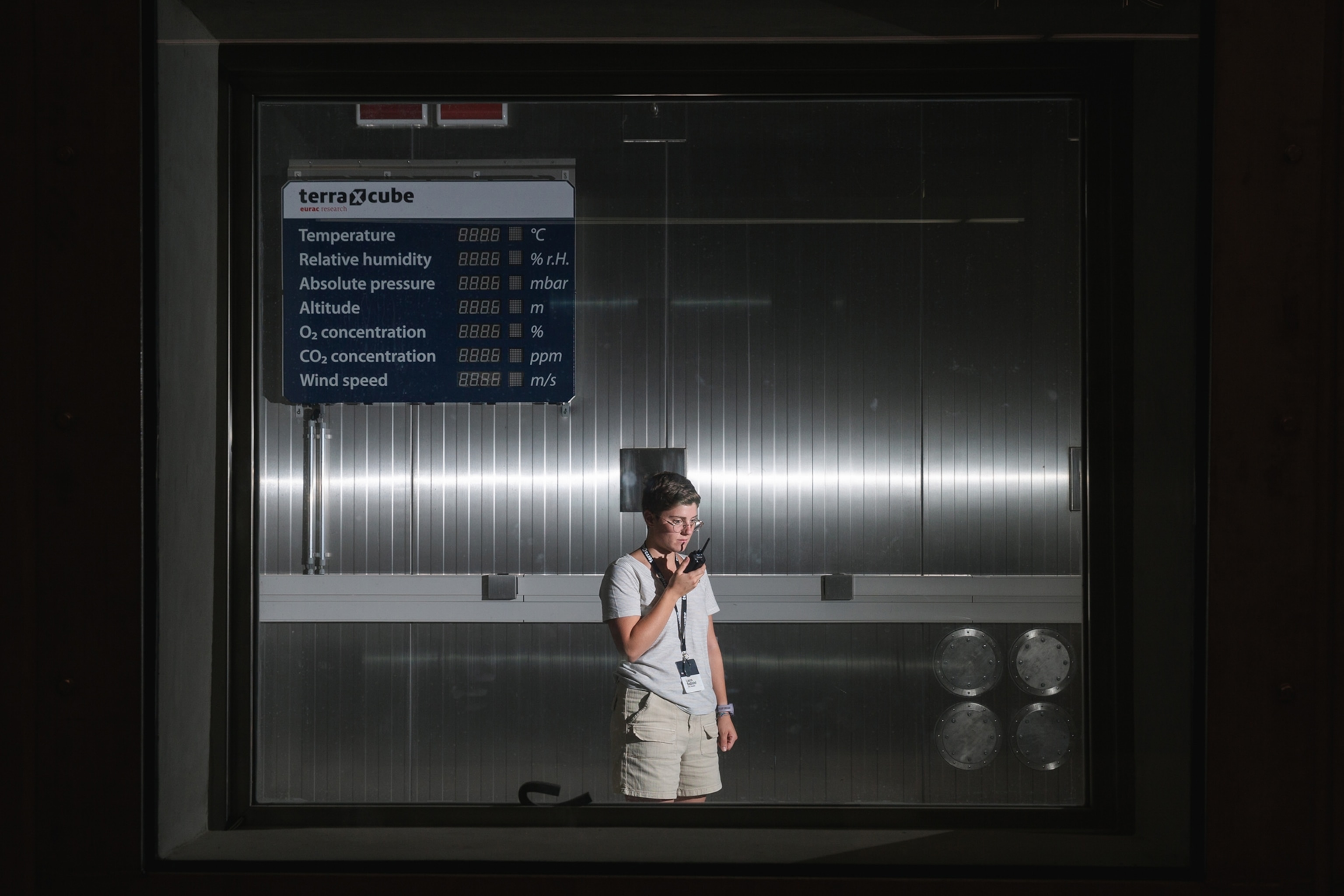 Researcher Laura Battistel in the biggest thermal chamber of terraXcube, at a moment when the room is not operating.
