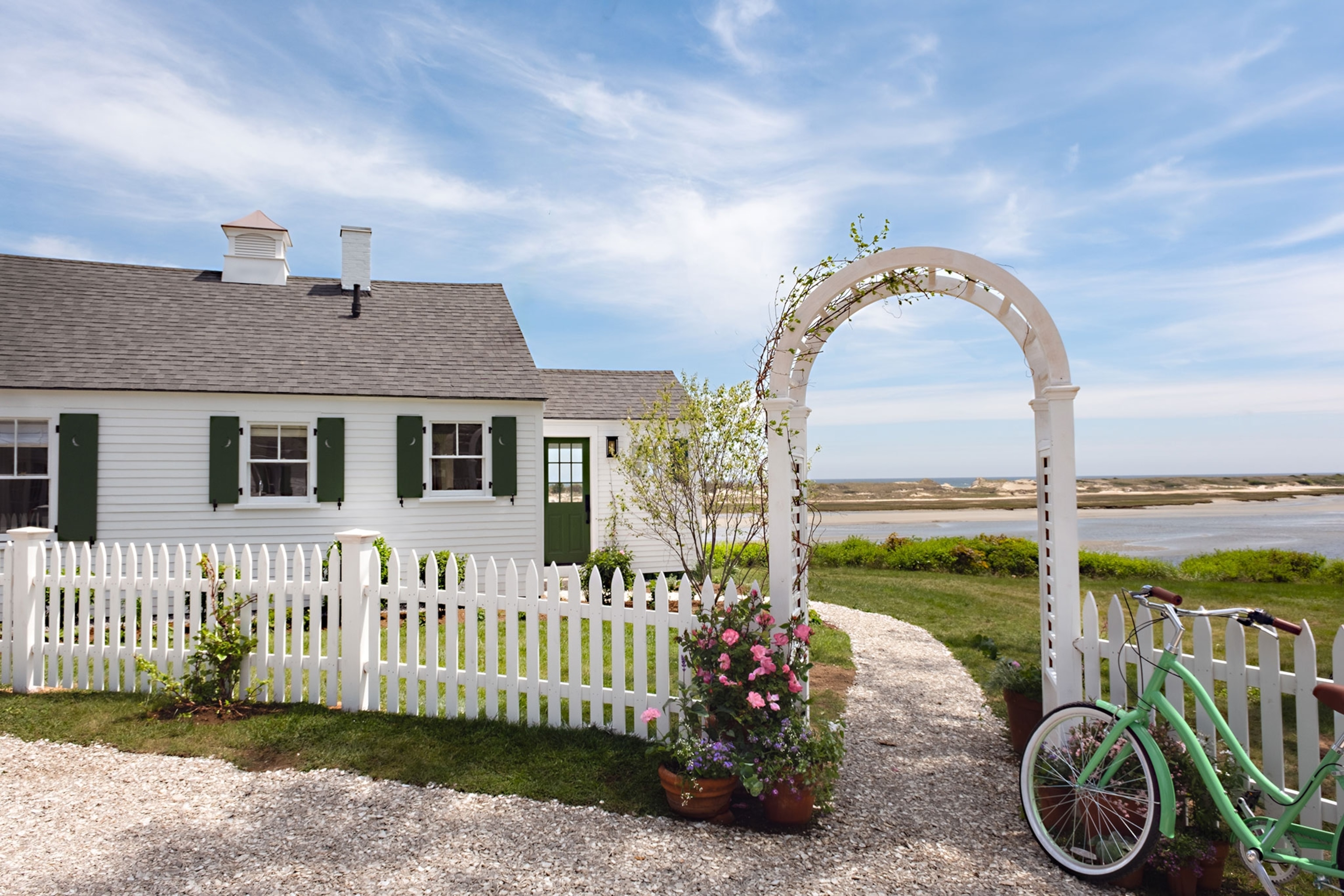 White cabin with White Picket fence