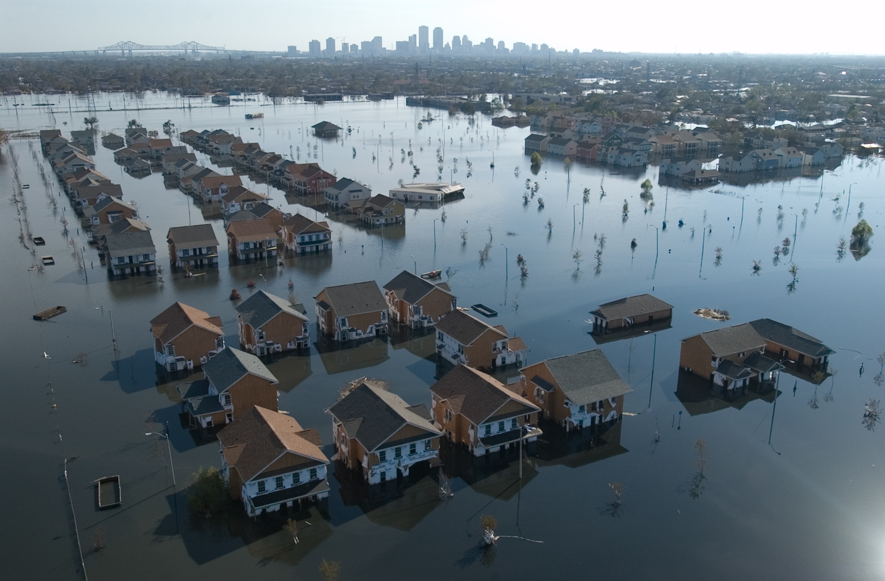 An aerial view of houses flooded by Hurricane Katrina with the city in the background