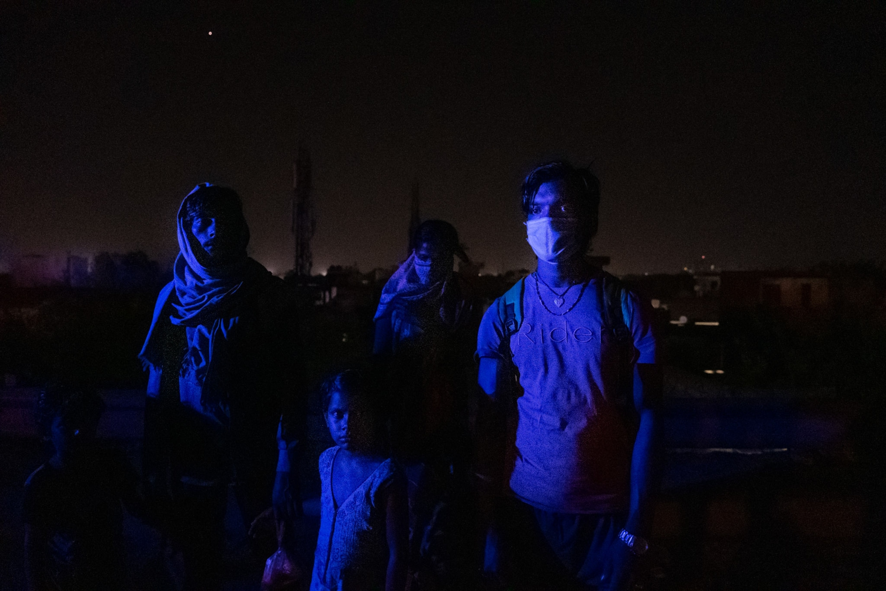 a few people lit up by blue lights
