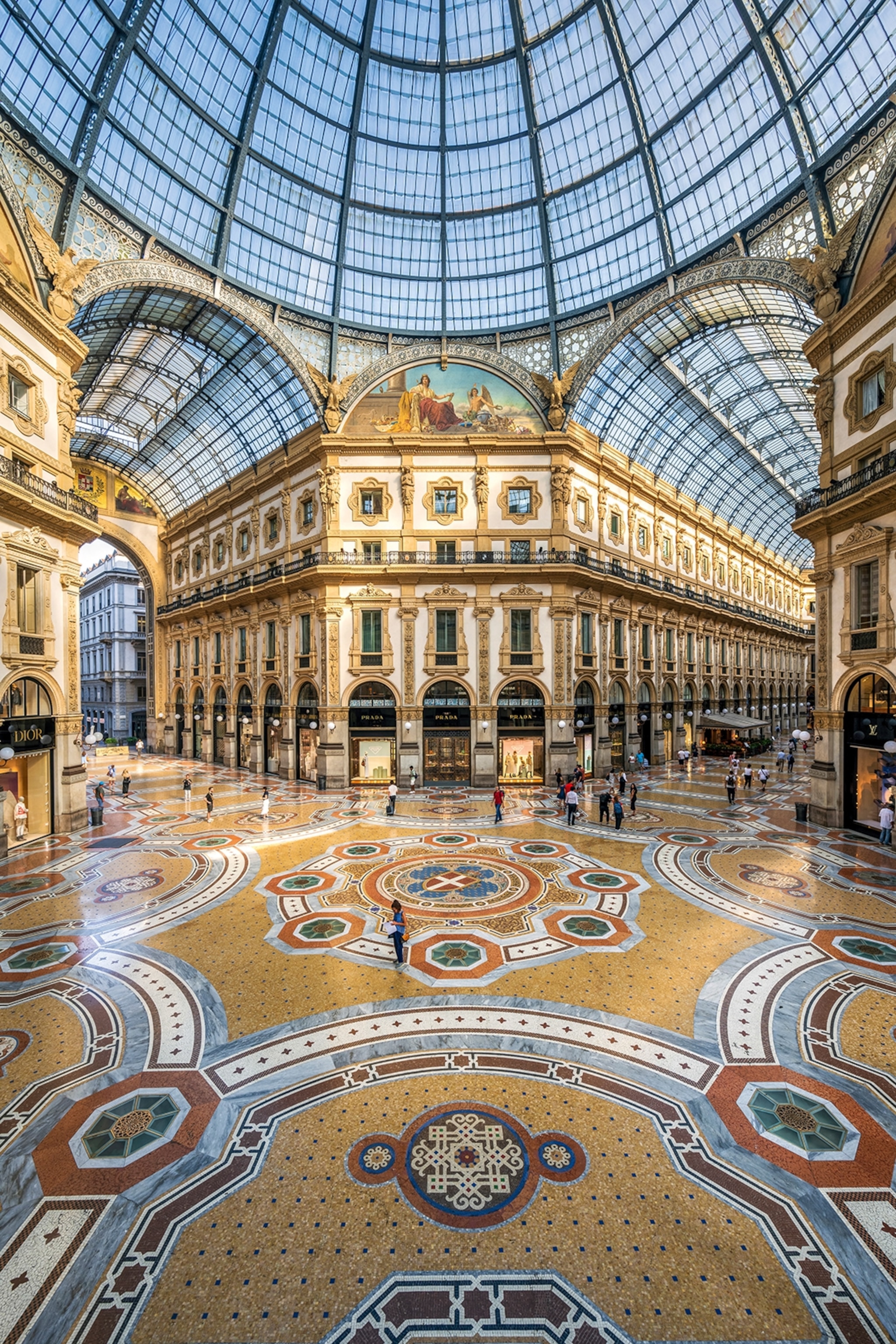 The interior of a splendid, glass-domed 19th Century shopping arcade in Milan.