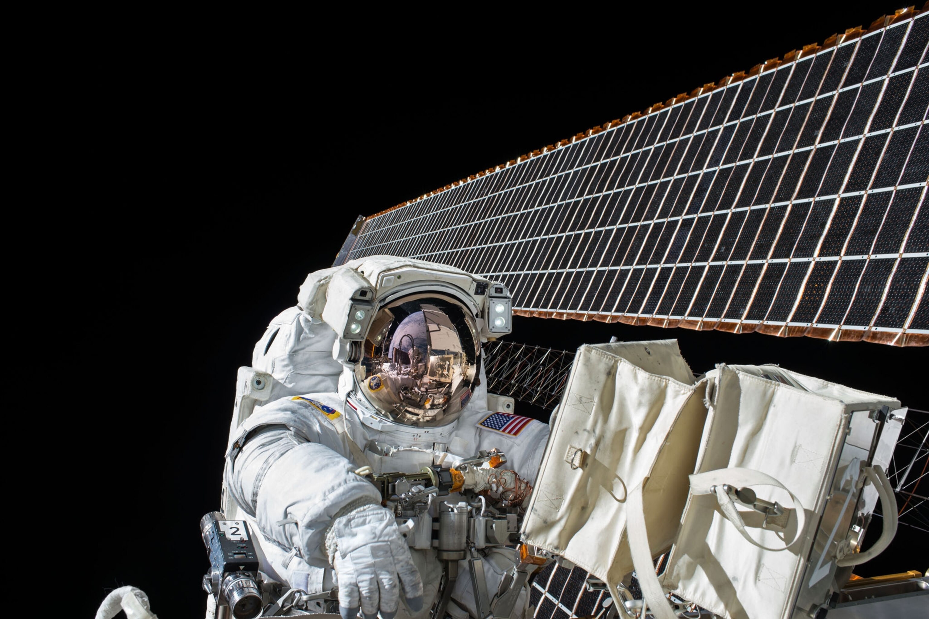 an astronaut on a spacewalk working on the exterior of the space station
