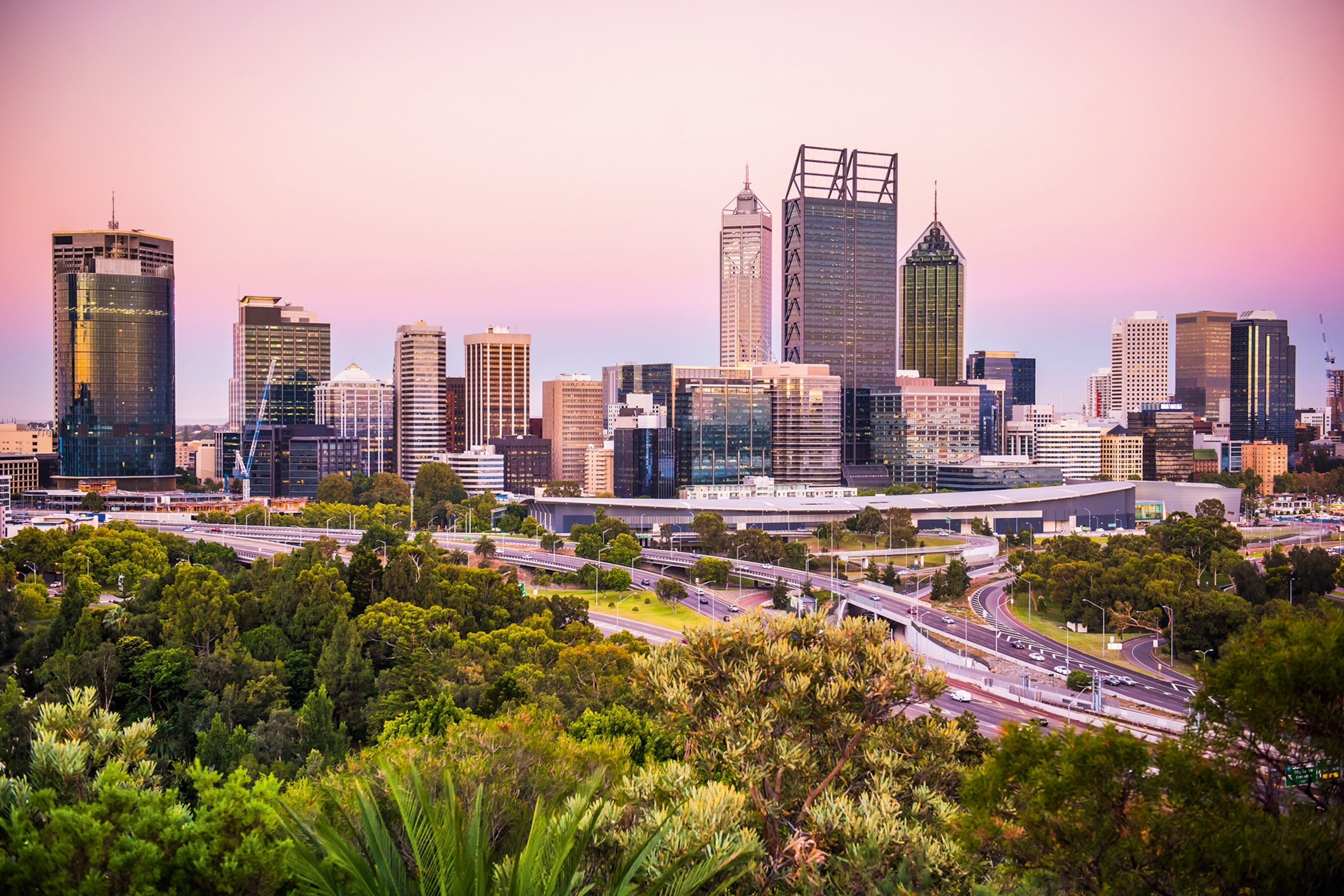 City skyline against a pink sunset hue