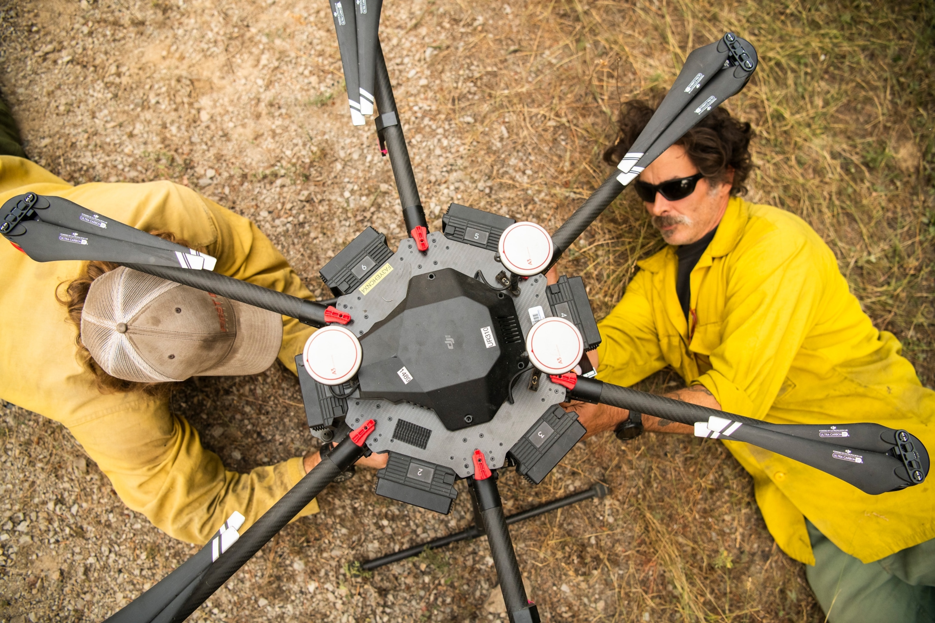 firefighters prepare a fire fighting drone
