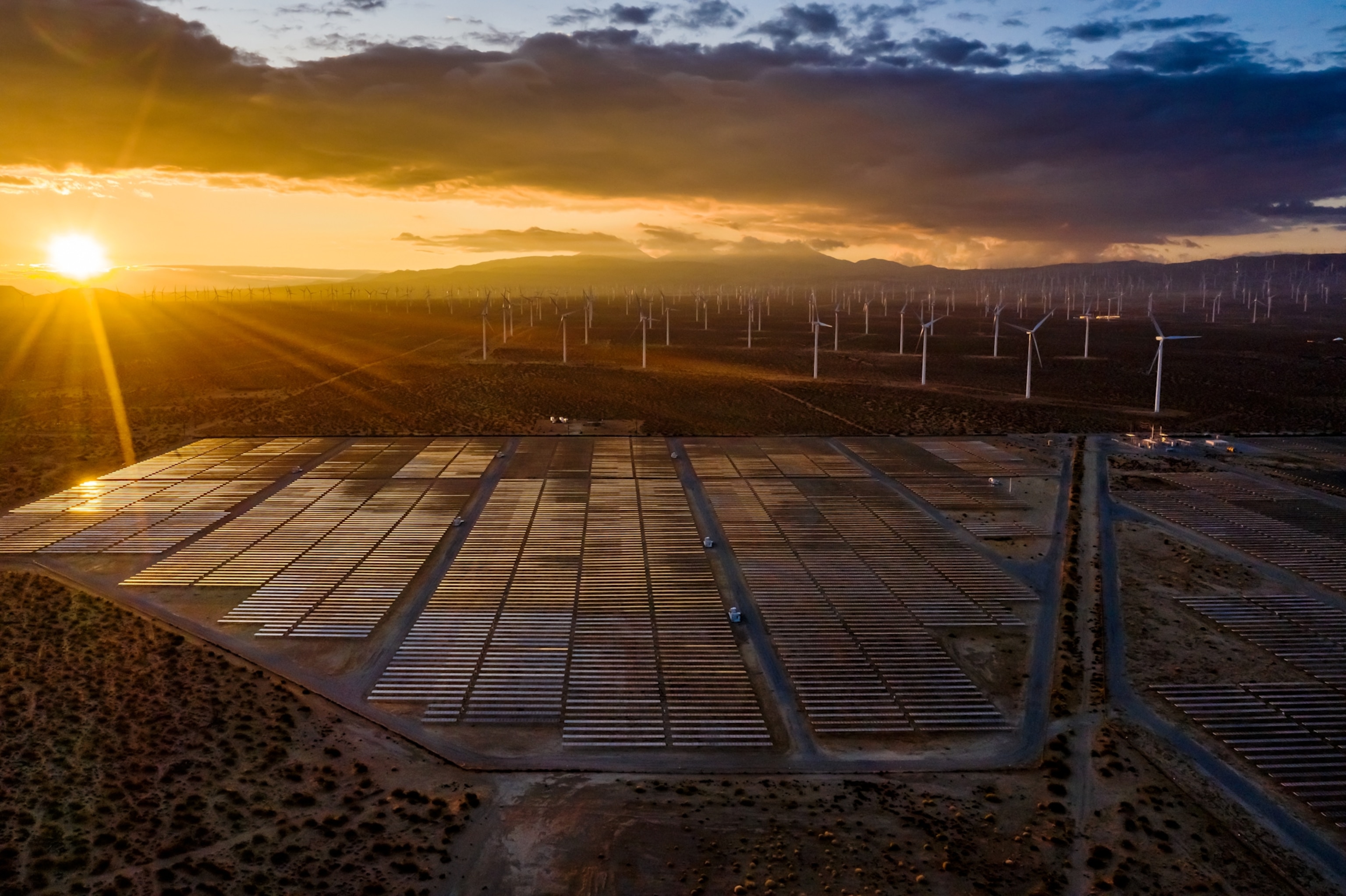 wind turbines and solar modules covering the land.