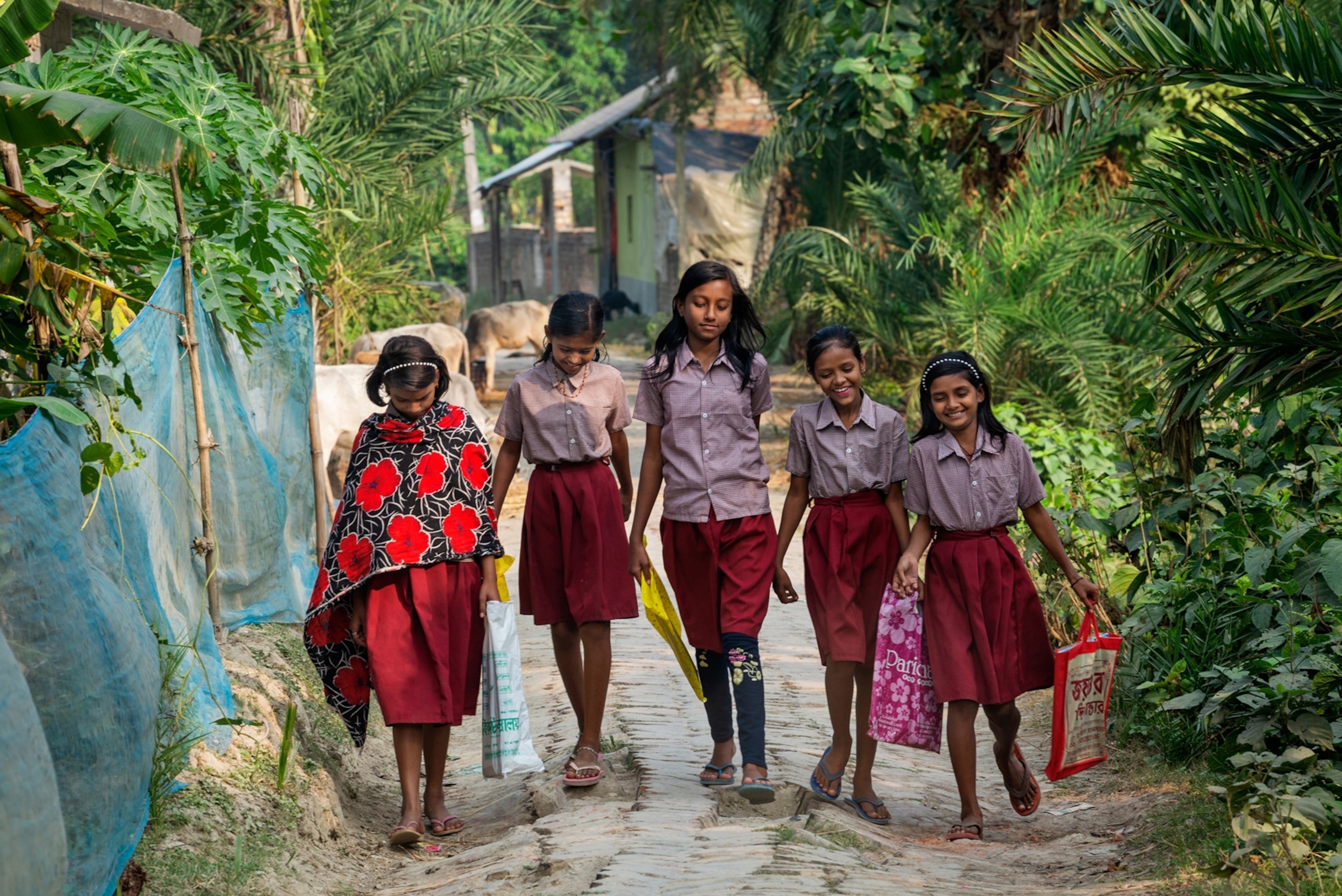 school girls walking down lane.