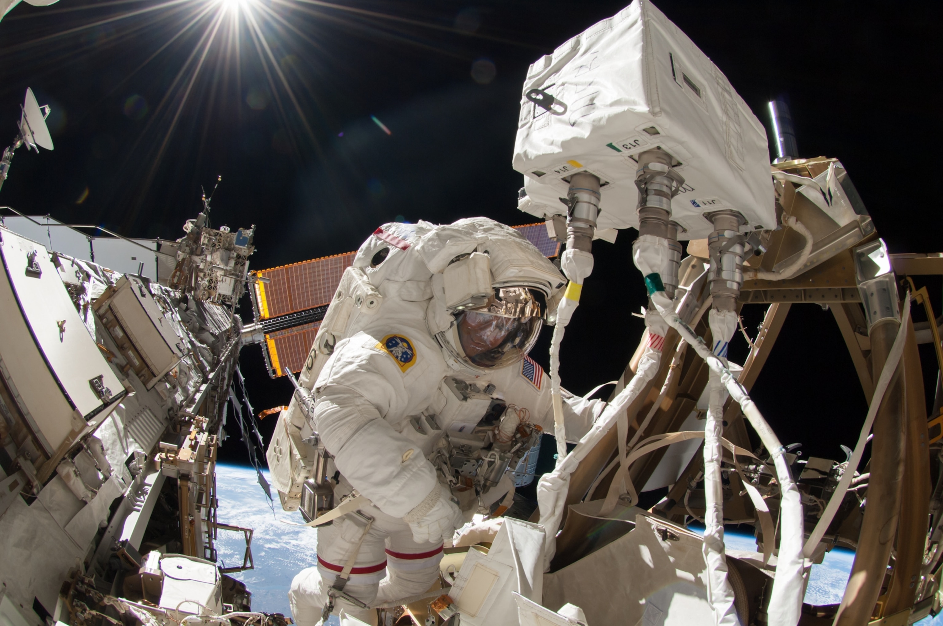 NASA astronaut Reid Wiseman is seen working on the outside structure of the International Space Station