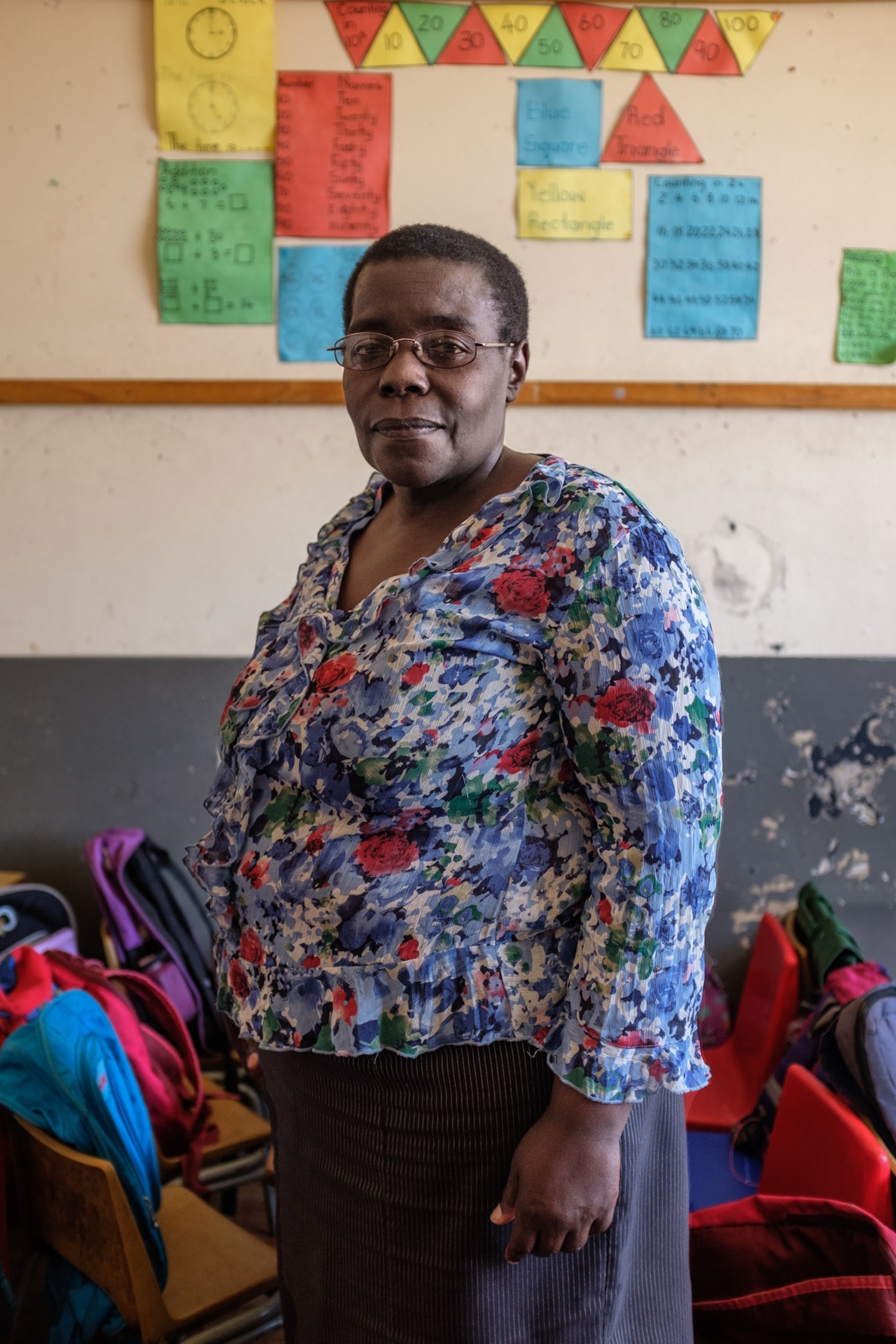 a woman standing in a schoolroom