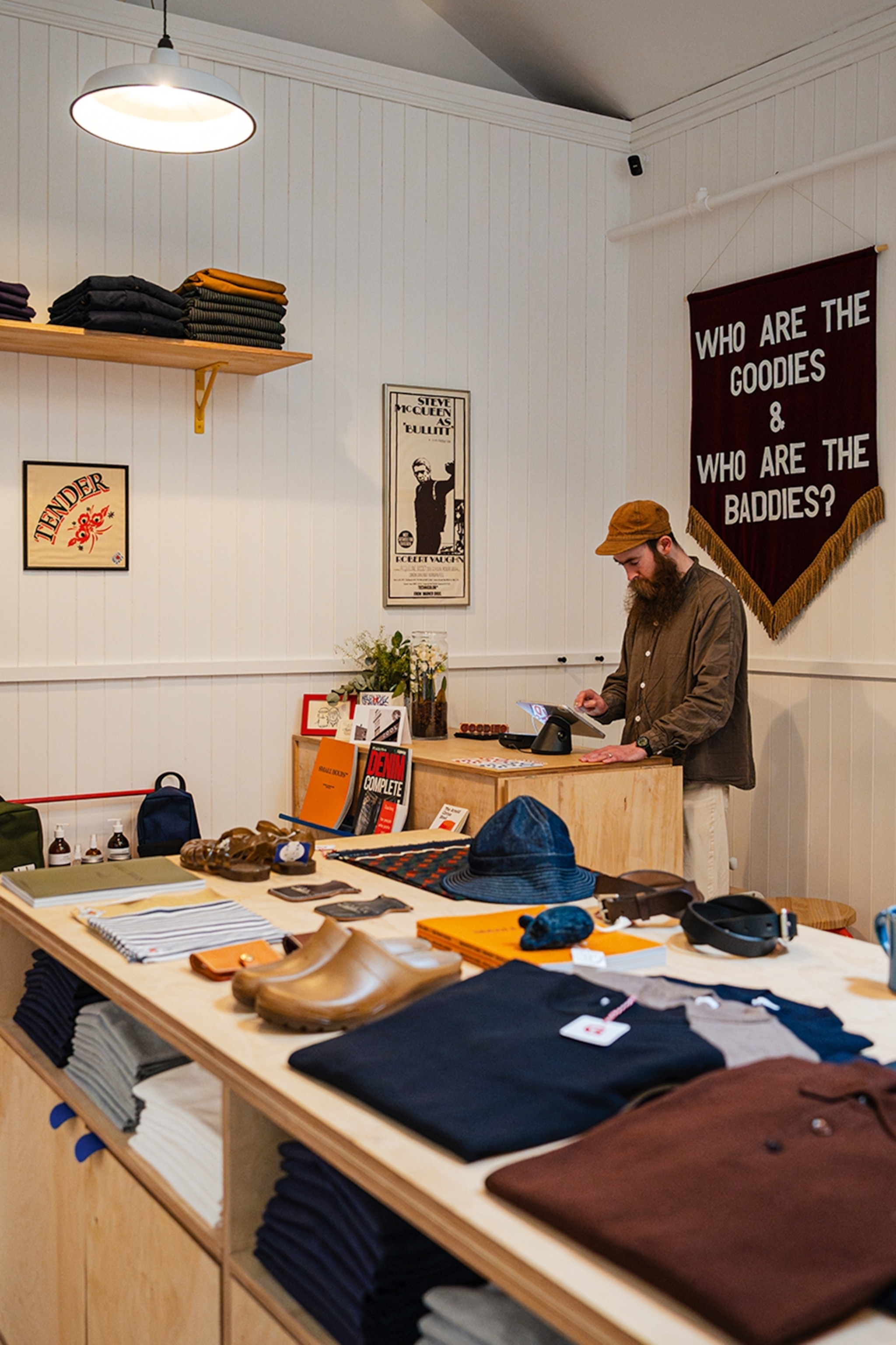 Man standing behind a counter in a clothing shop
