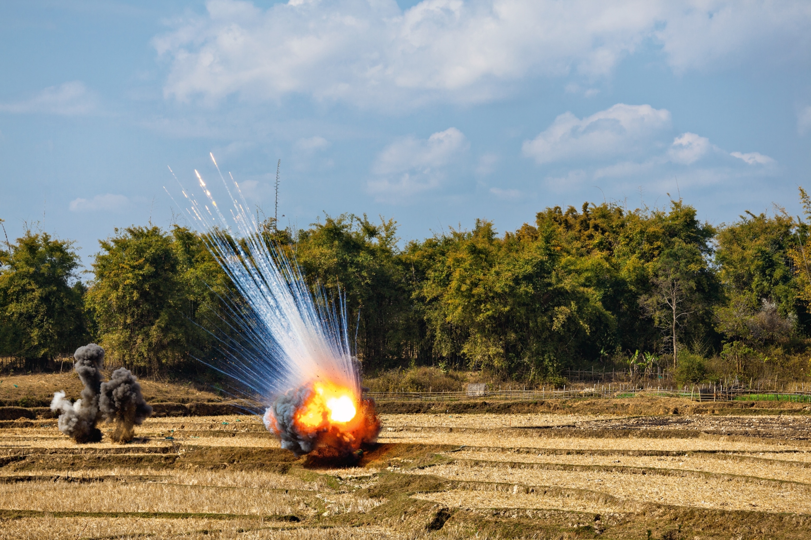 munitions being destroyed to make a field safe in Laos