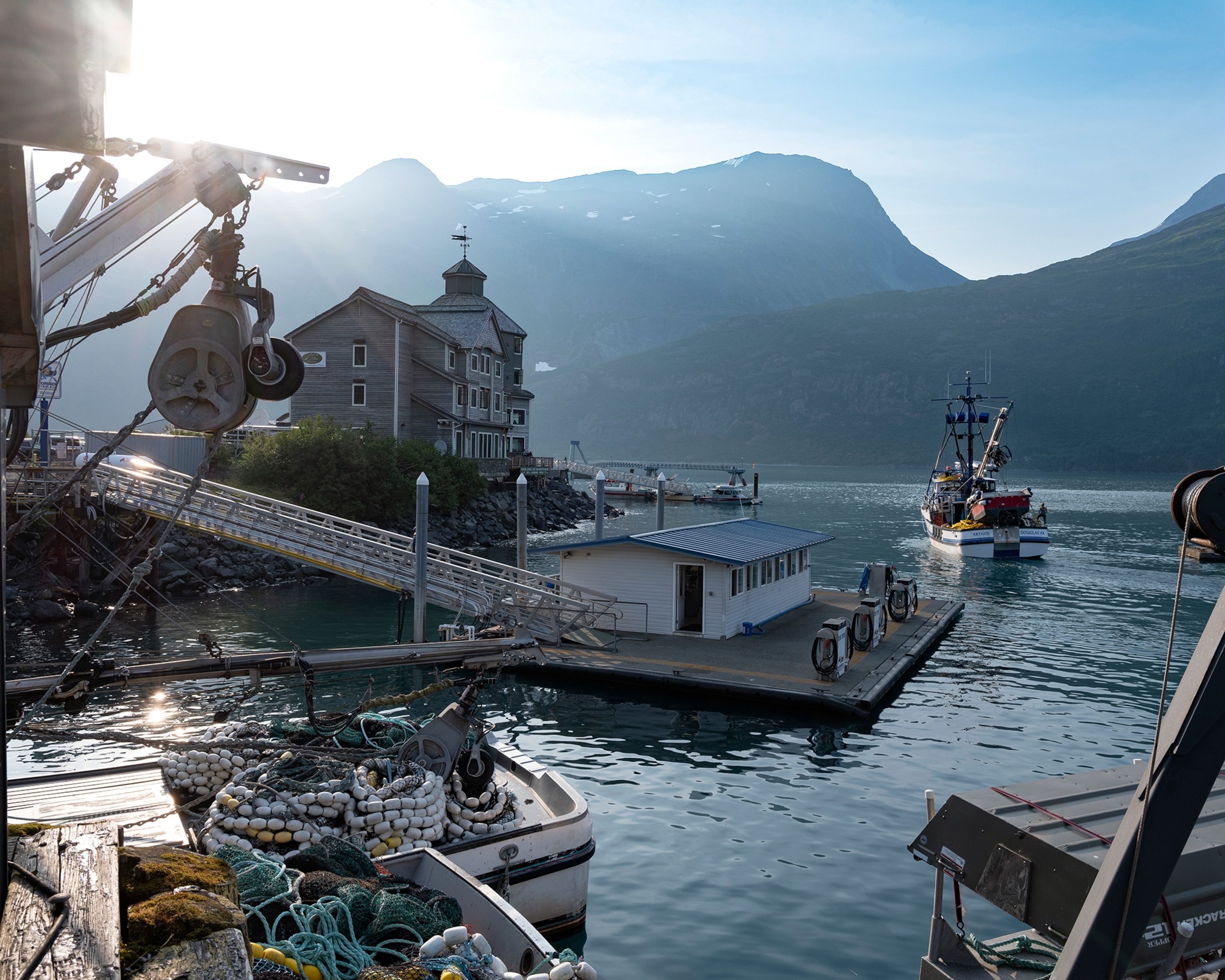 A fishing trawler motors out from the port of Whittier.
