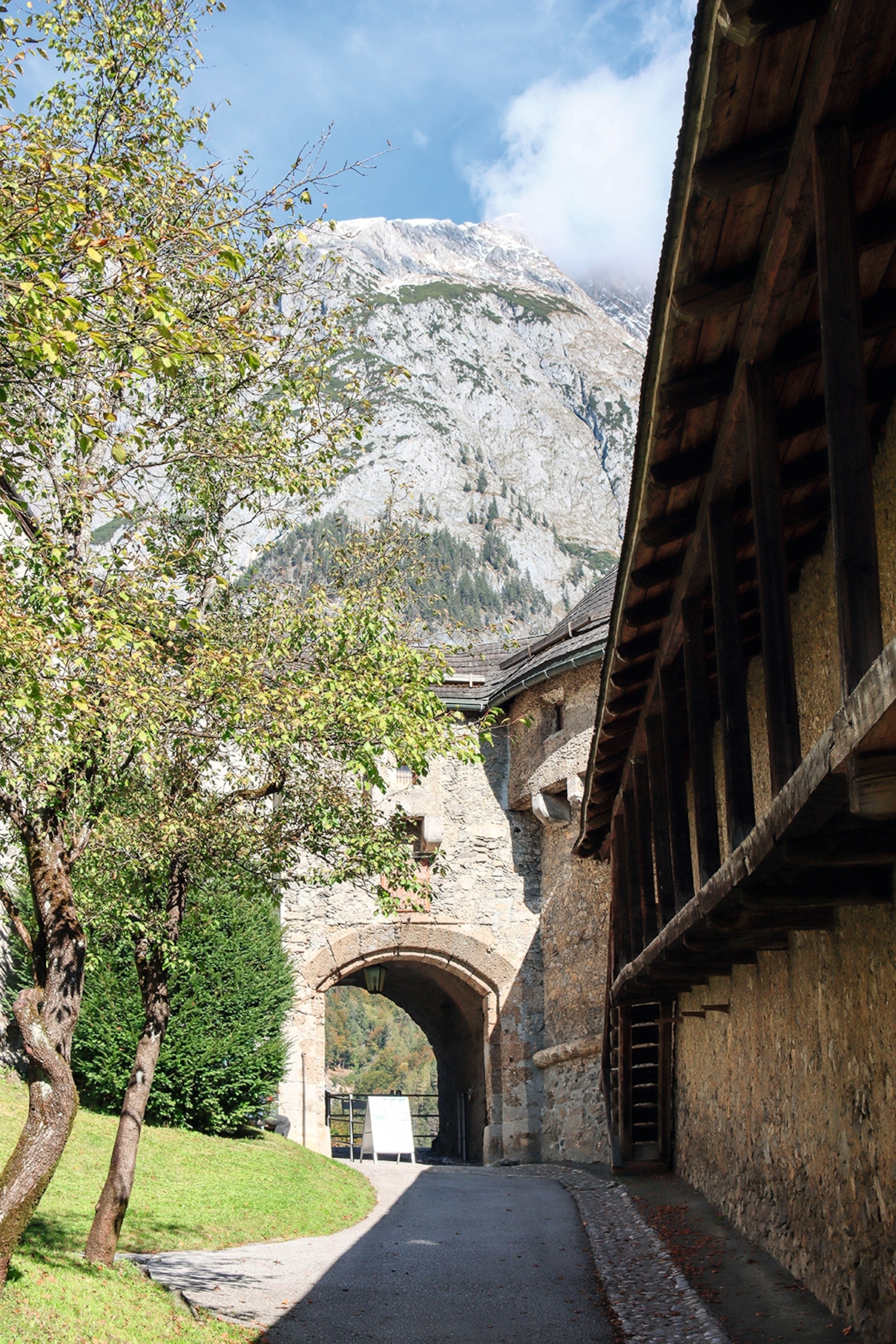 The walk to a birck archway in Werfens Hohenwerfen castle. Mountains tower over the castle in the background.