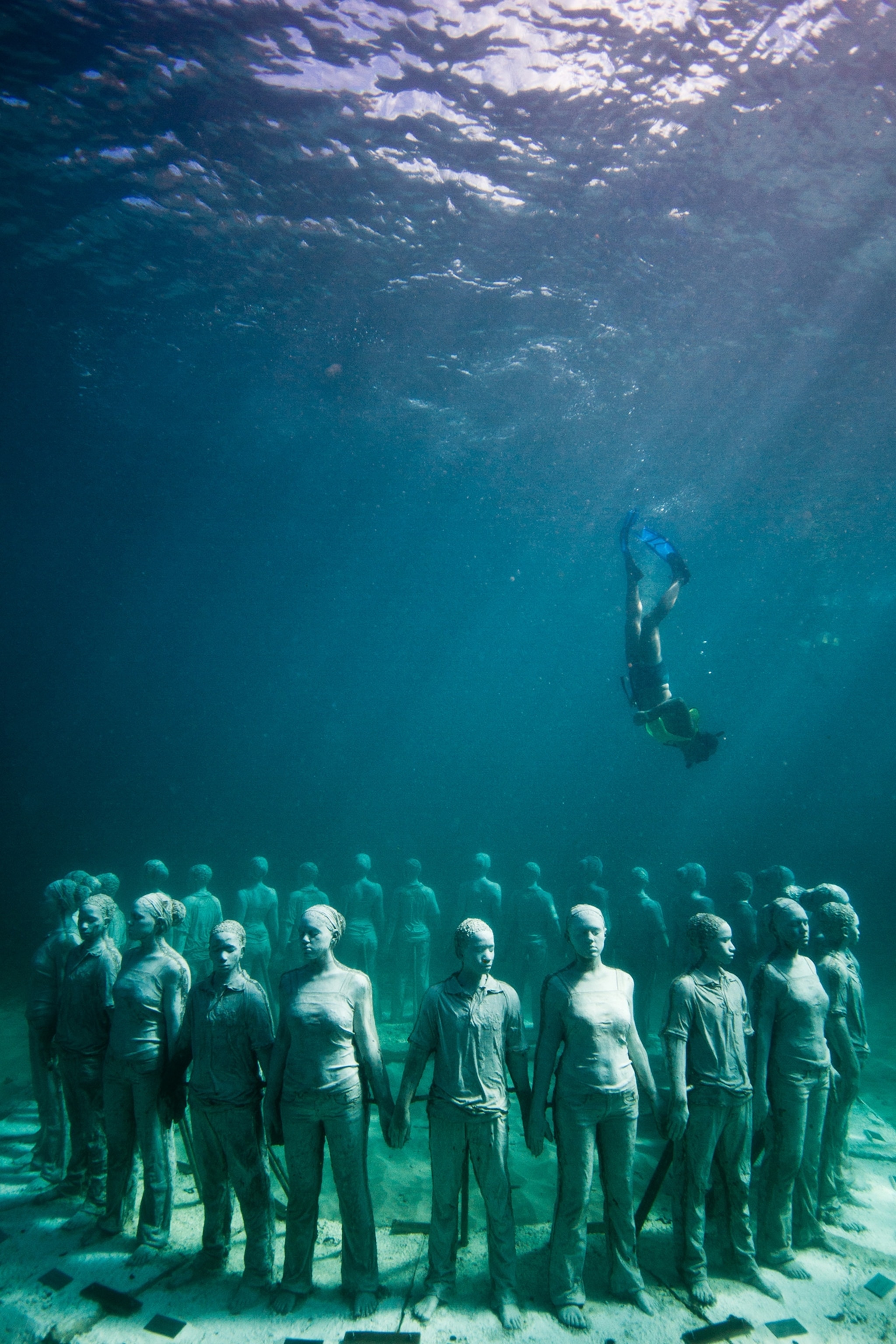 Local dive guides showing the Vicissitudes installation to visitors.