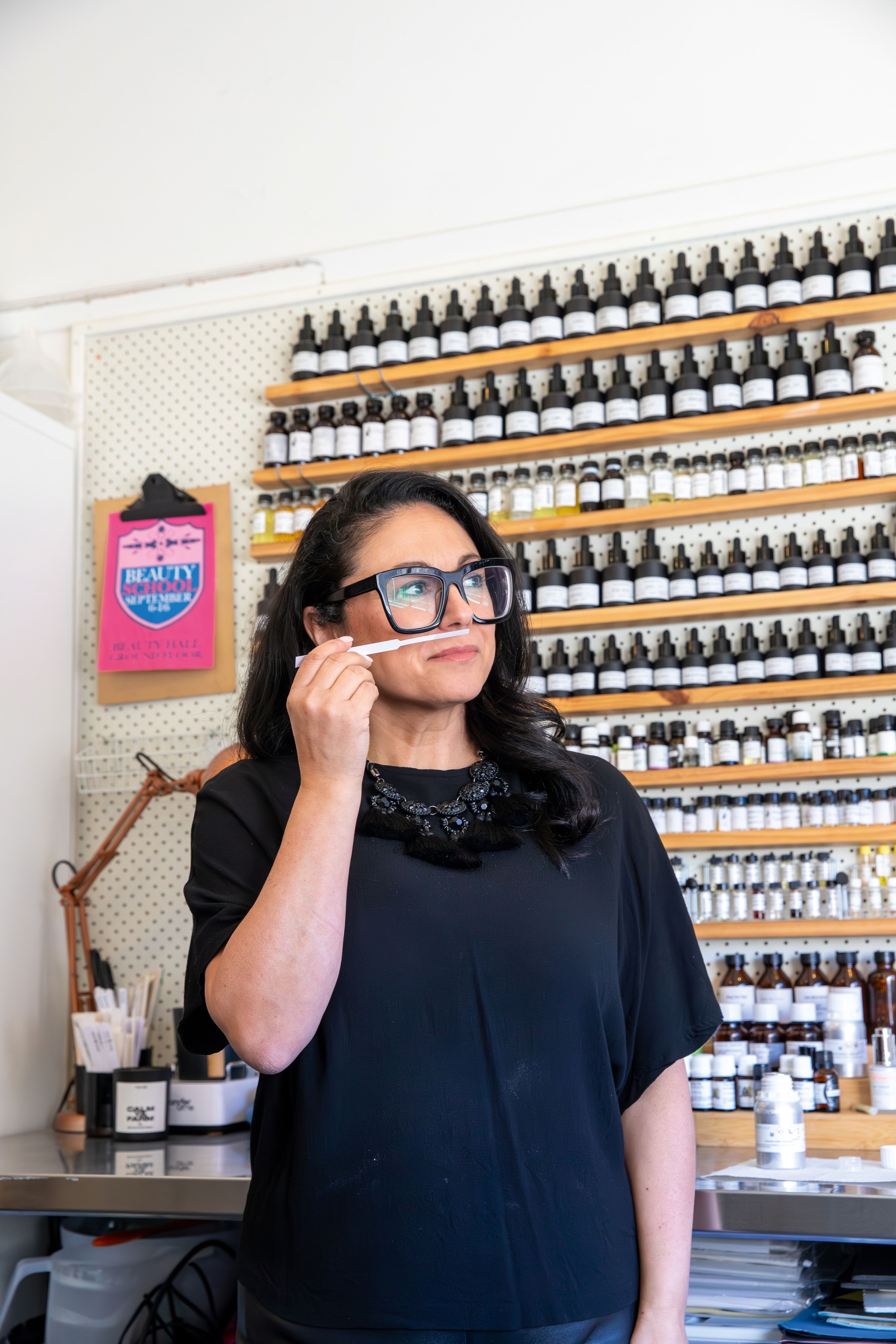 woman scenting fragrance tester