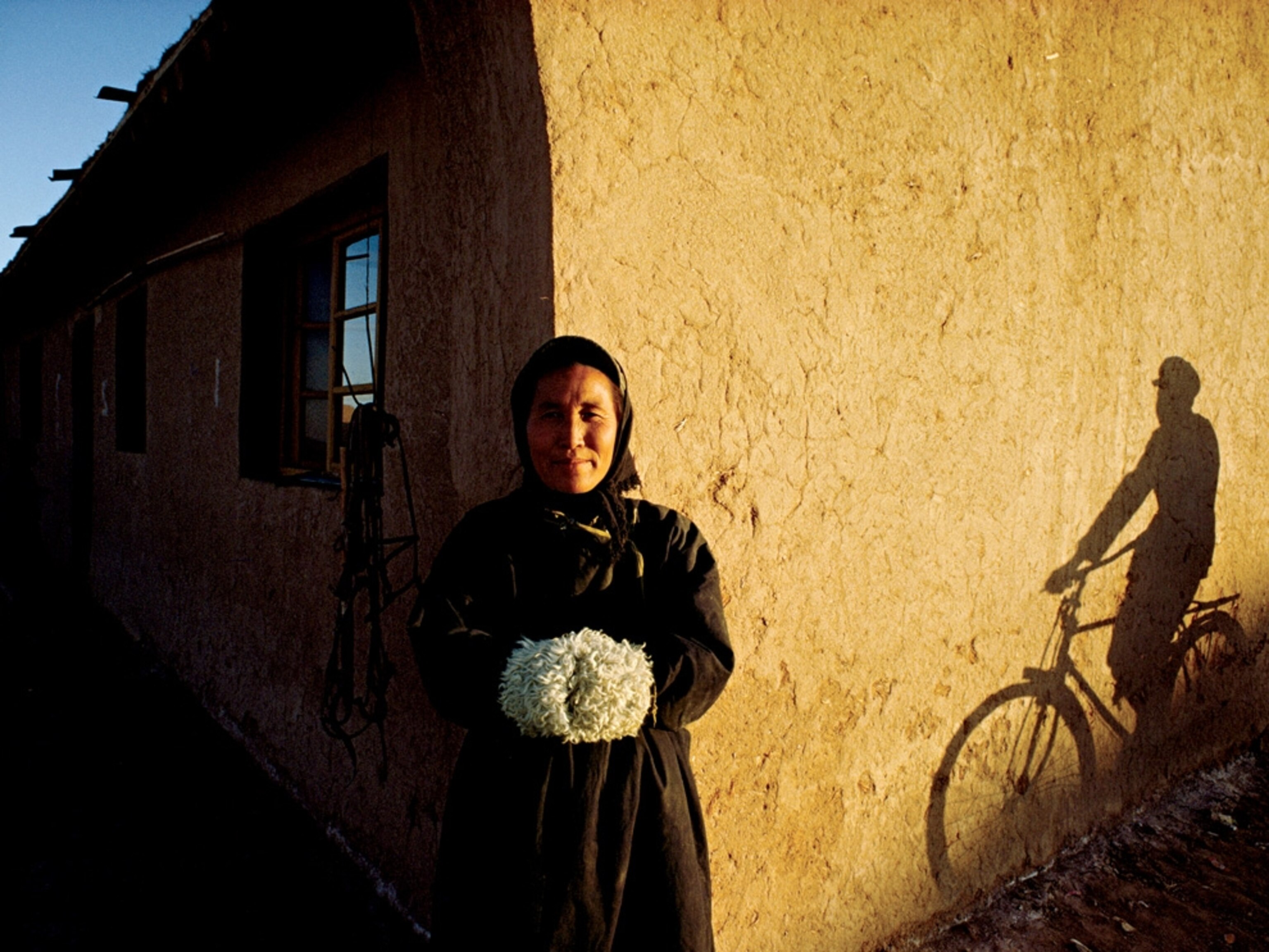 Woman standing near the corner of a building
