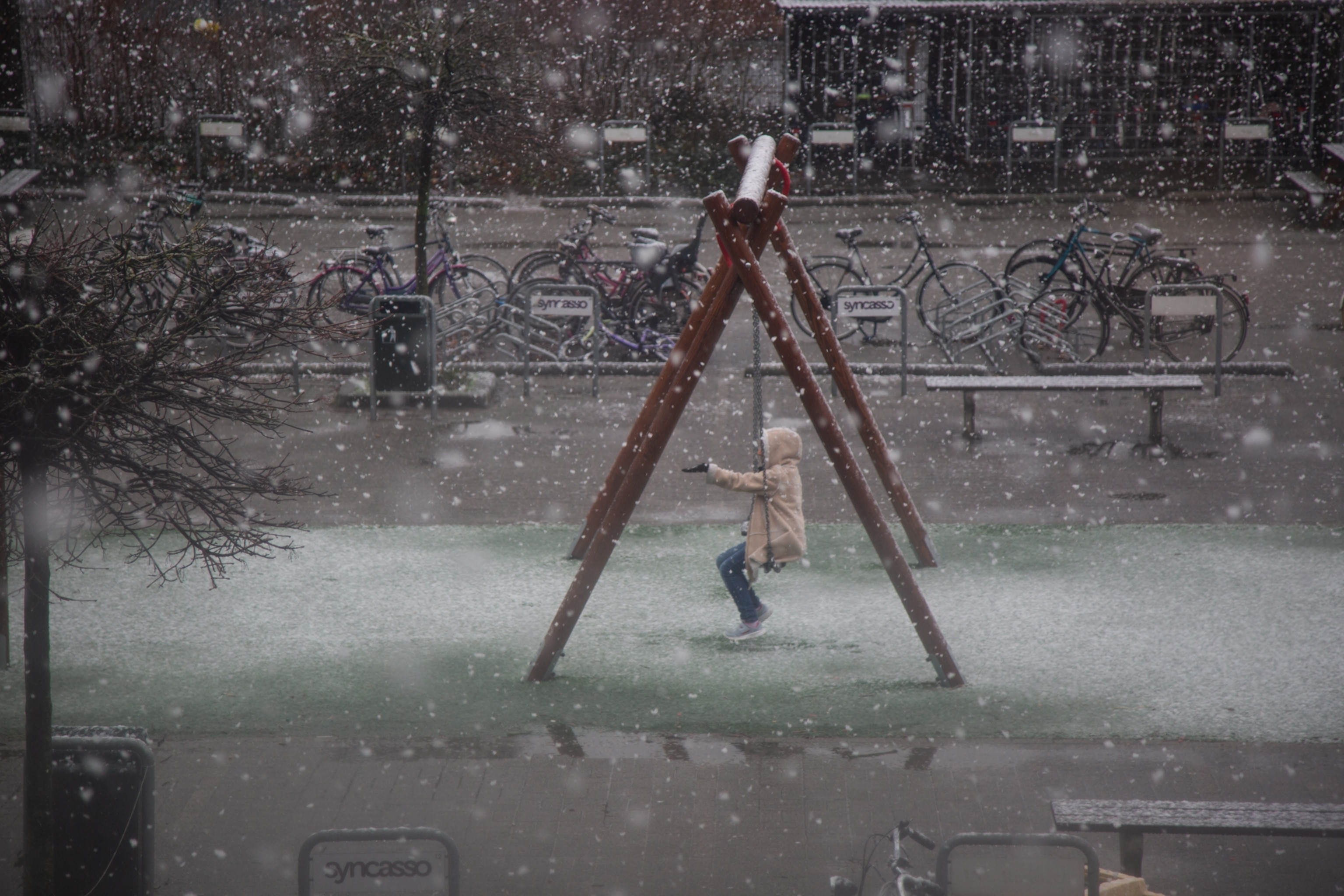 a young girl on a swing in the snow