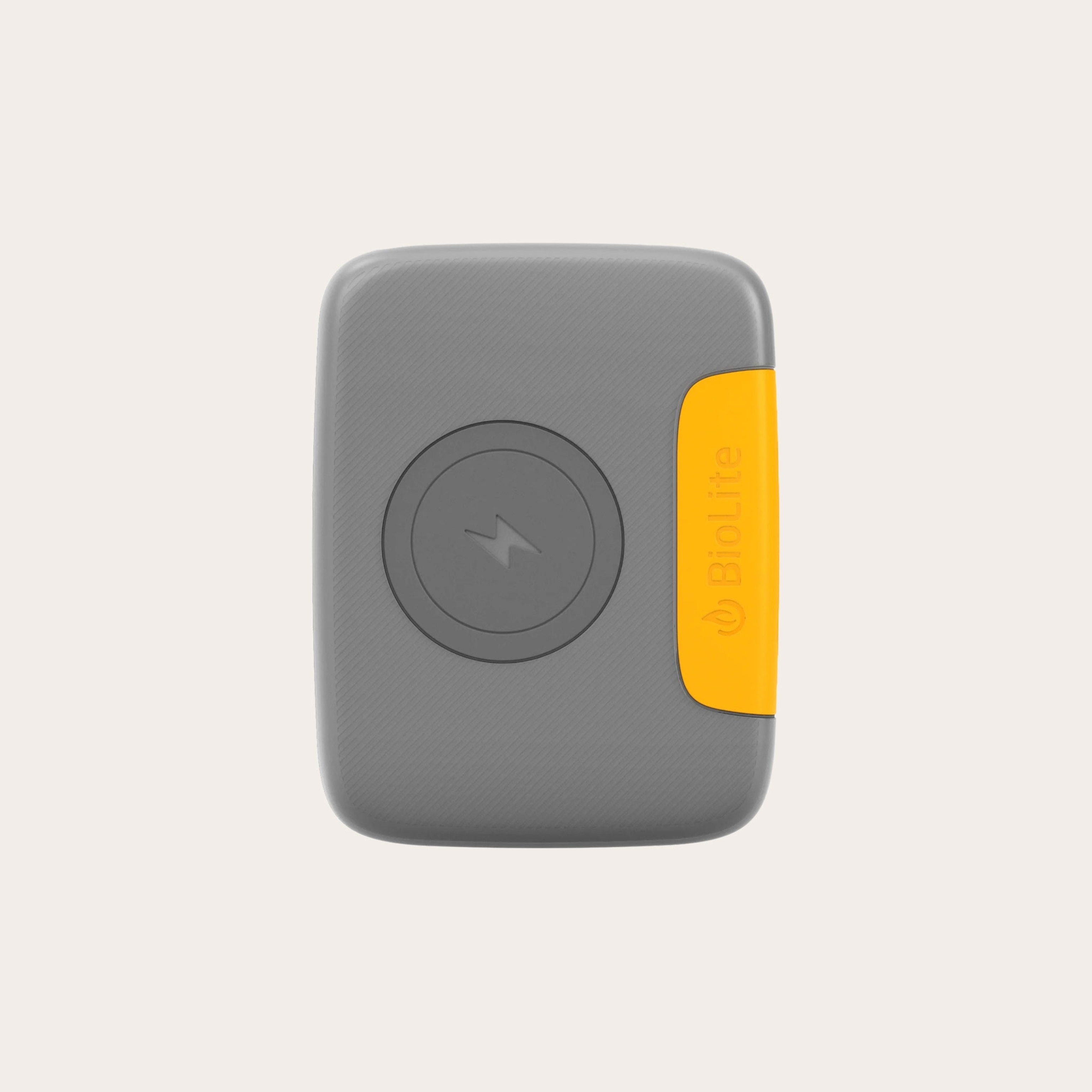 Grey and yellow rectangular charing block placed on a tan background.