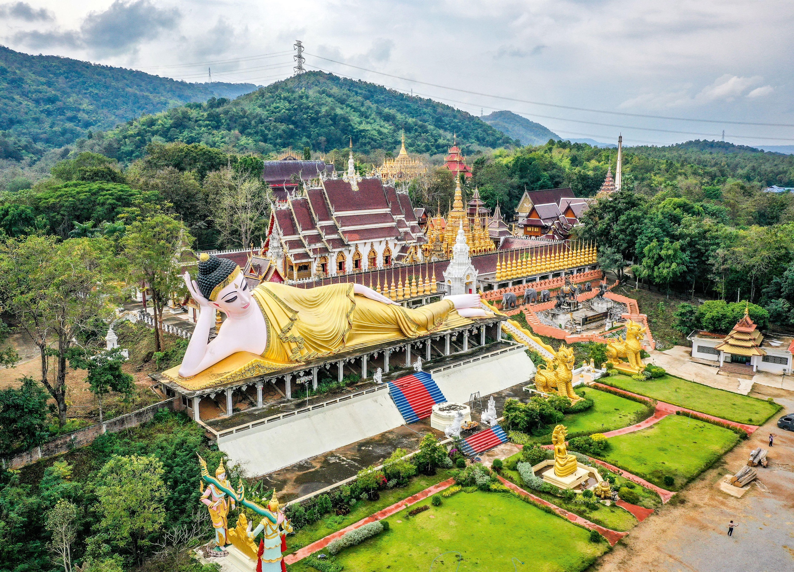 Ornate temple complex surrounded by forested hills