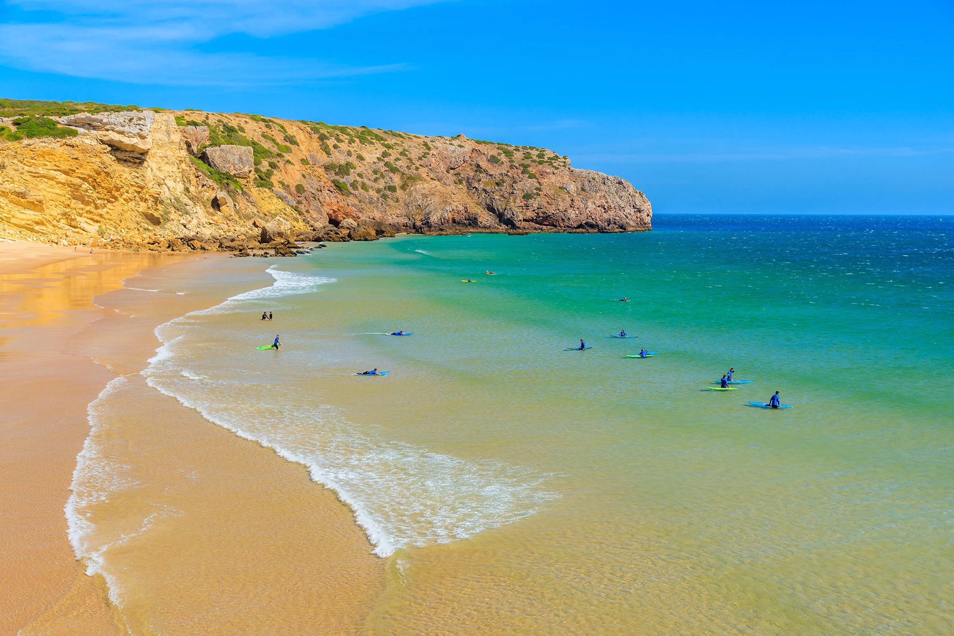 surfers in the Algarve region of Portugal