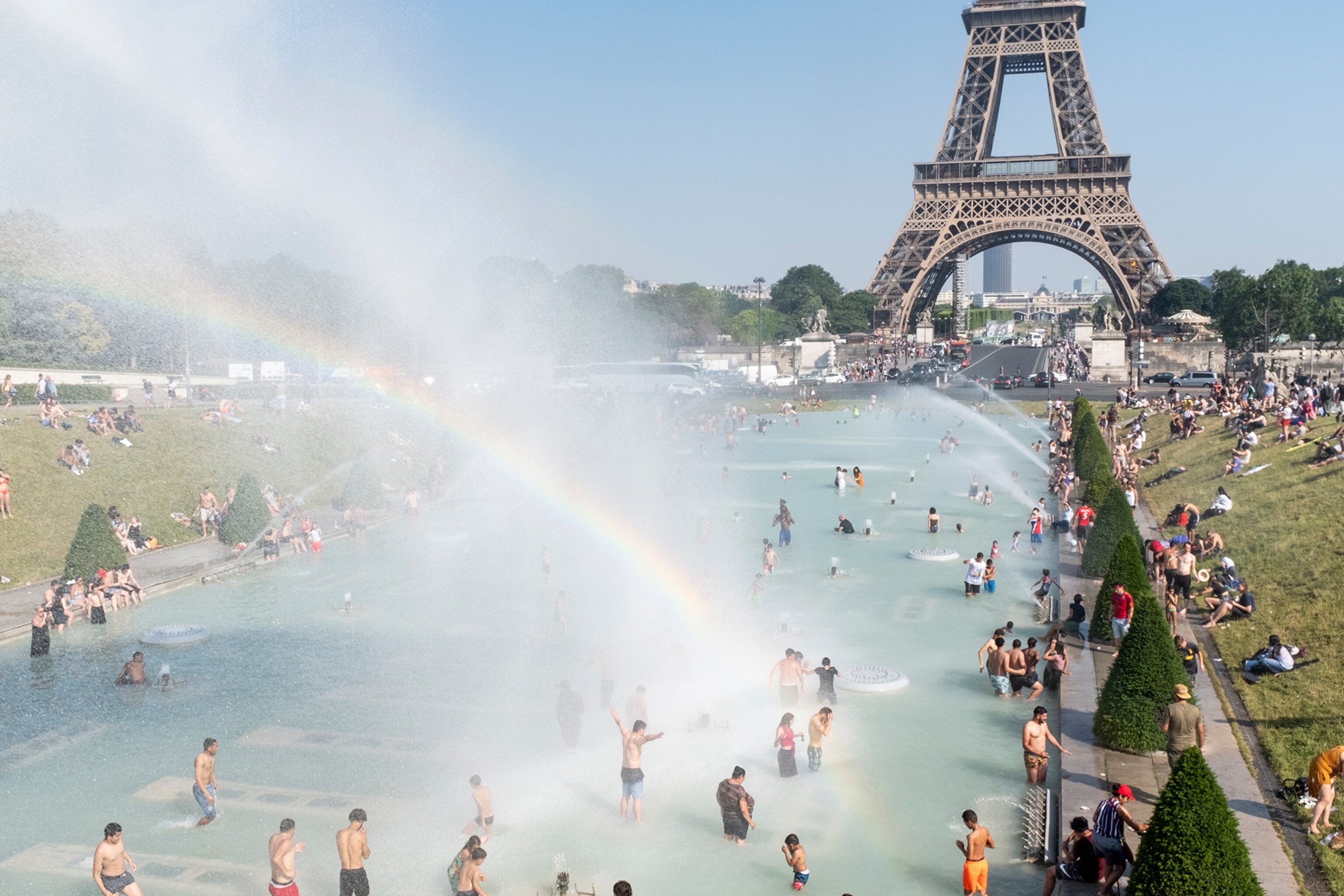 people swimming in the Trocadero fountain to cool off