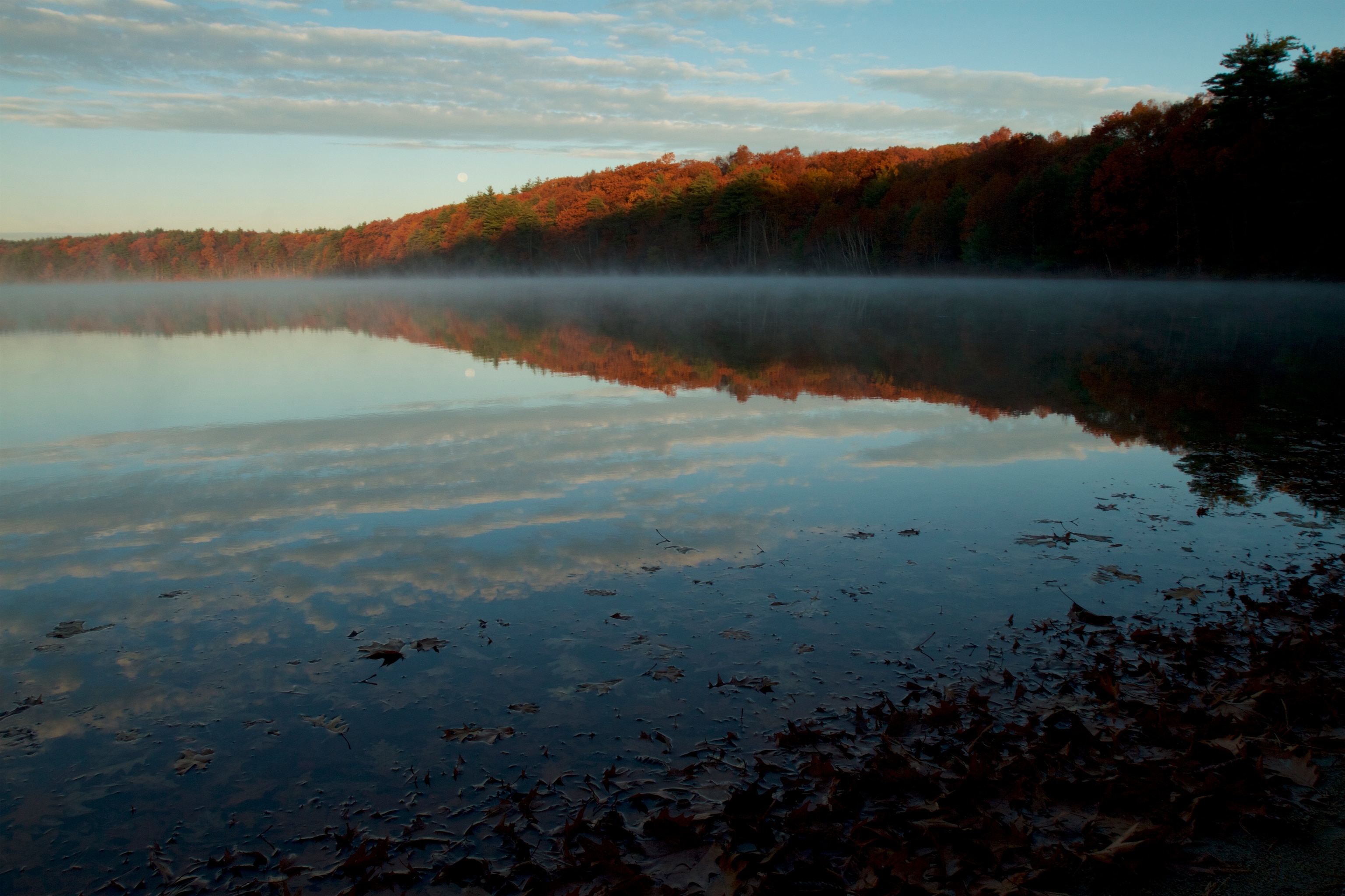 Morning mist rises from Walden Pond in the fall