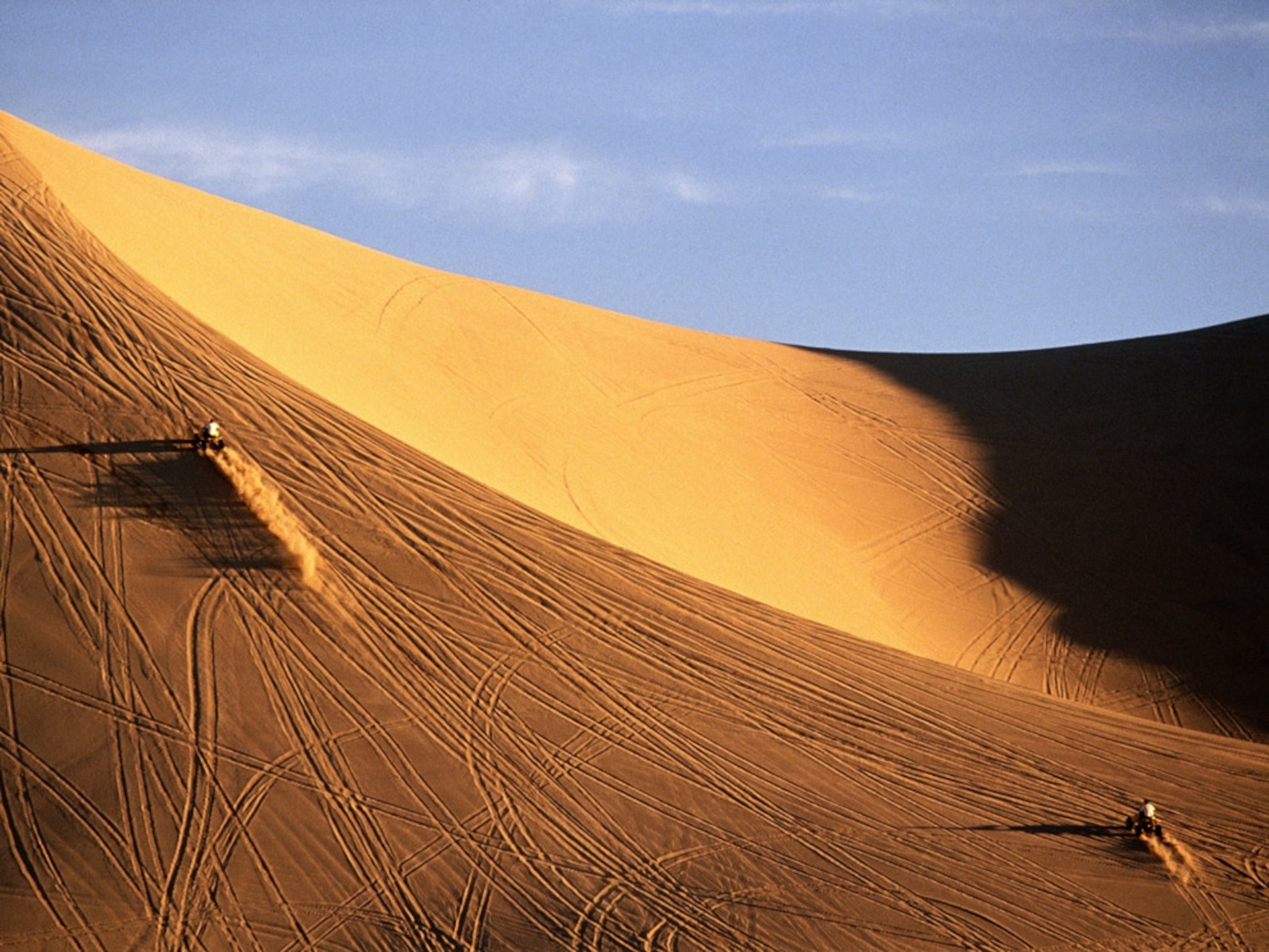 People riding quadbikes on dune in Dumont Dunes, California