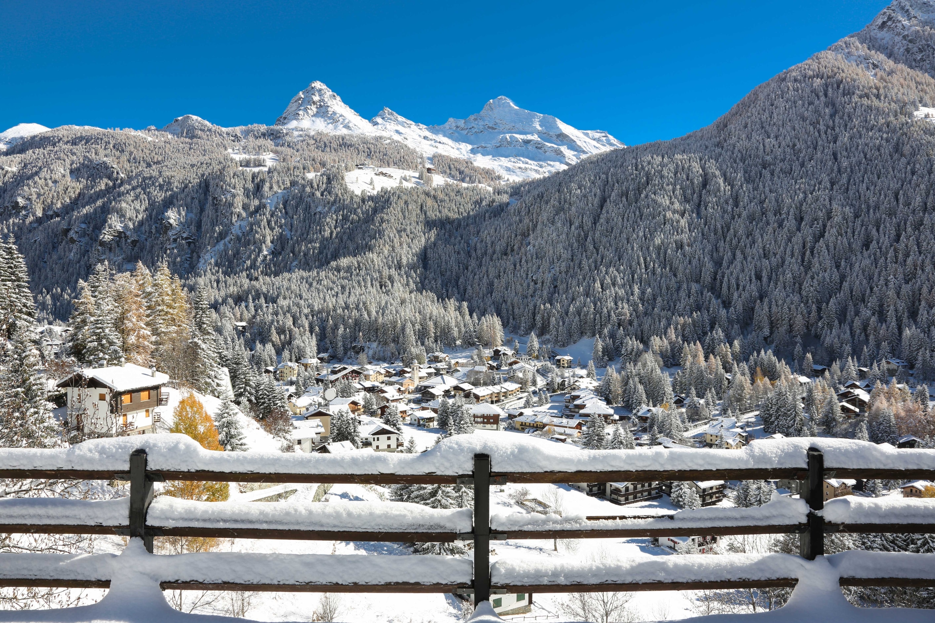 Snow-covered mountains against a bright blue sky