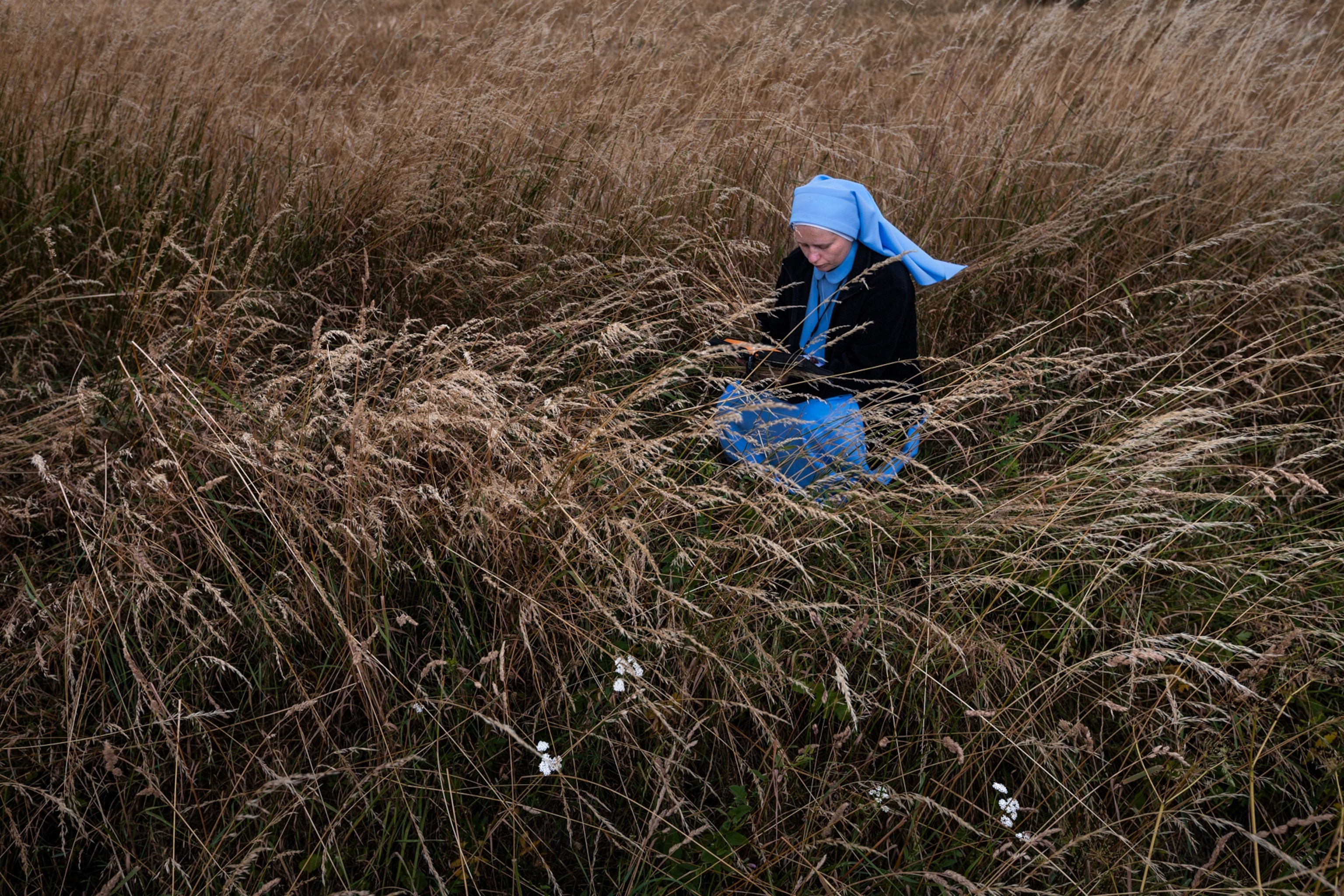 a Polish nun praying in a field