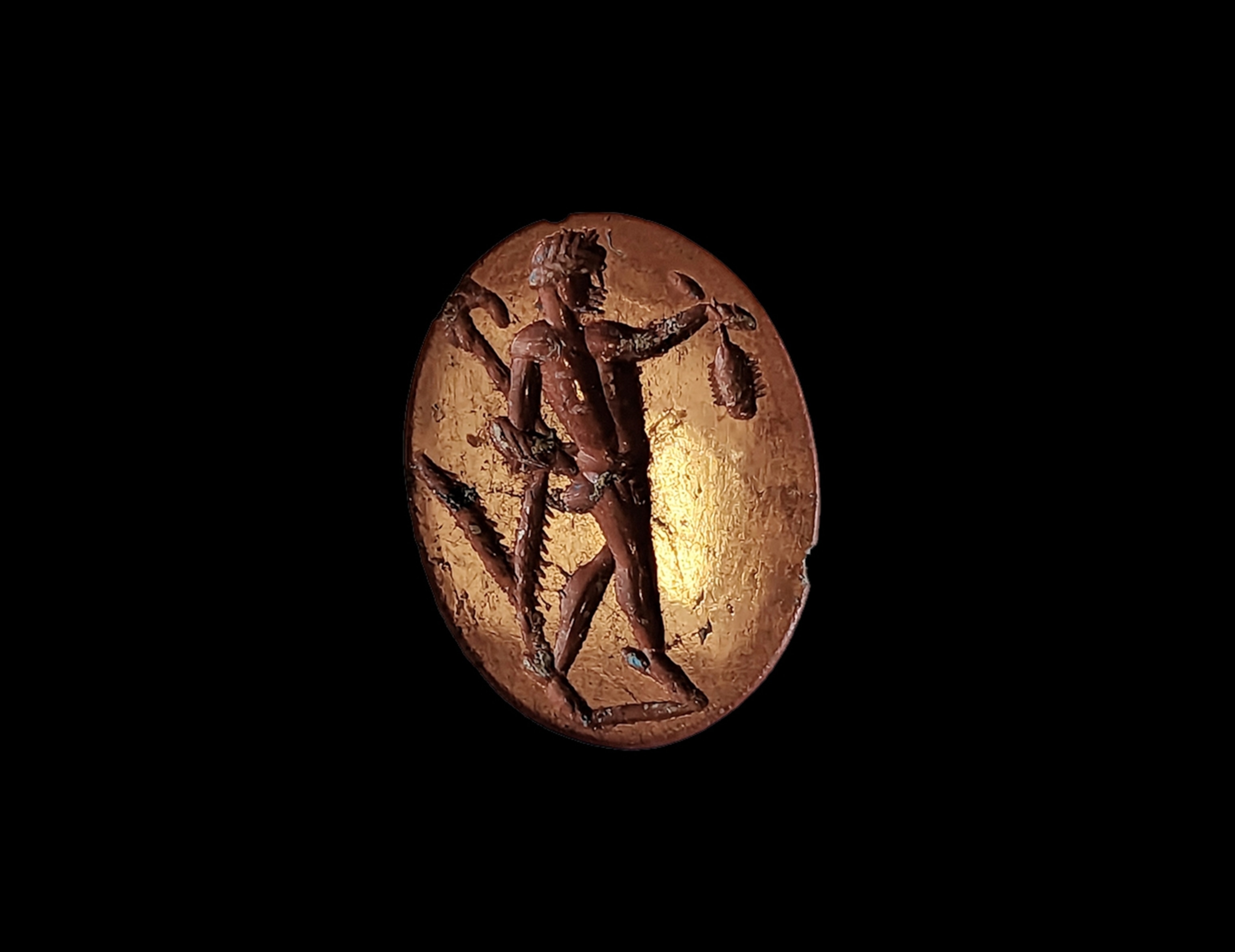 A satyr walks or dances on tip toe to the right, holding out his left arm with a bunch of grapes(?) in his hand; he holds a pedum (a staff used for multiple purposes) or lagobolon (a throwing stick for killing game) in his right hand and an animal skin (nebris) is draped over his forearm, though in this case it is misunderstood and appears to bifurcate. There is a ground line.