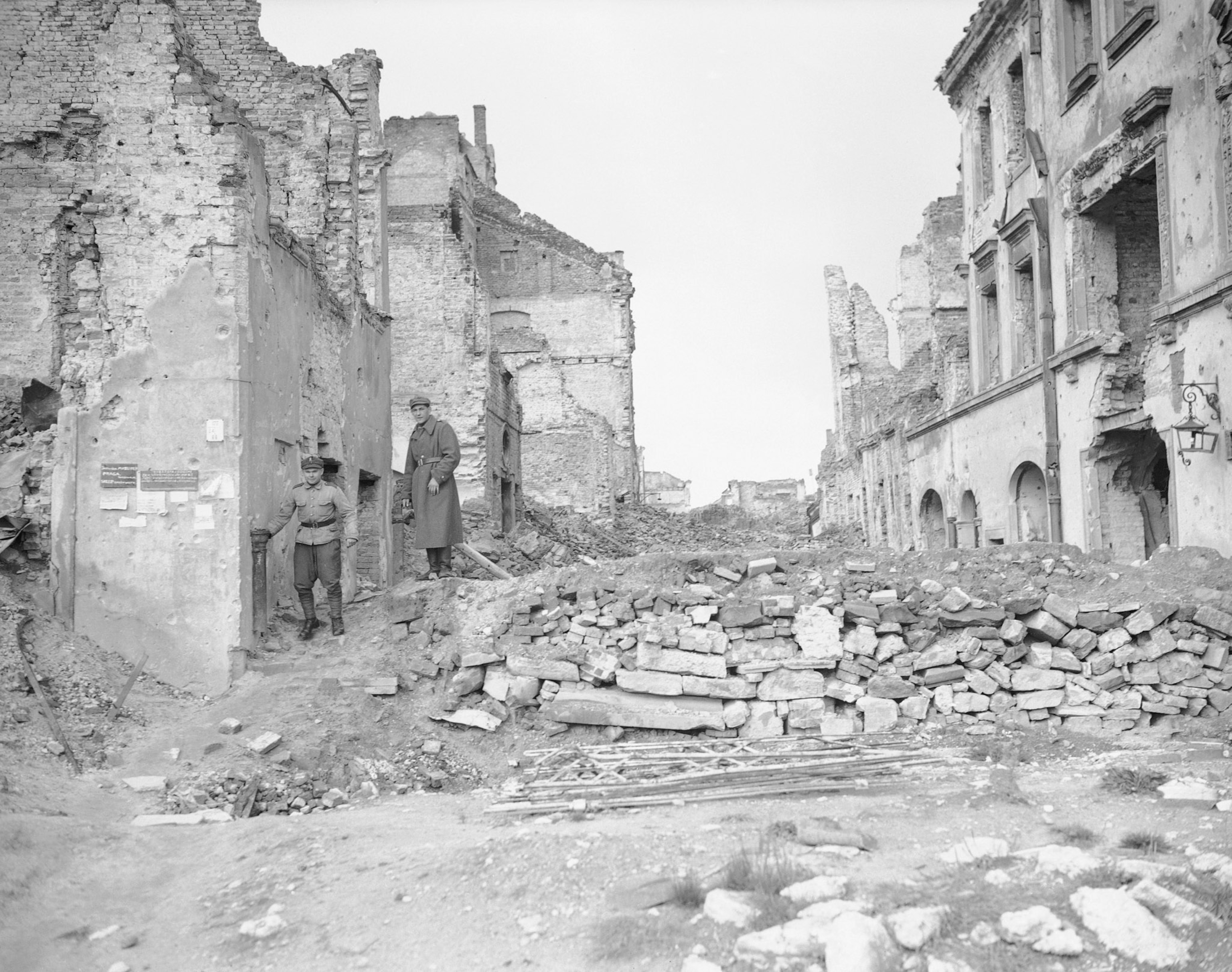 a people walking through a destroyed city