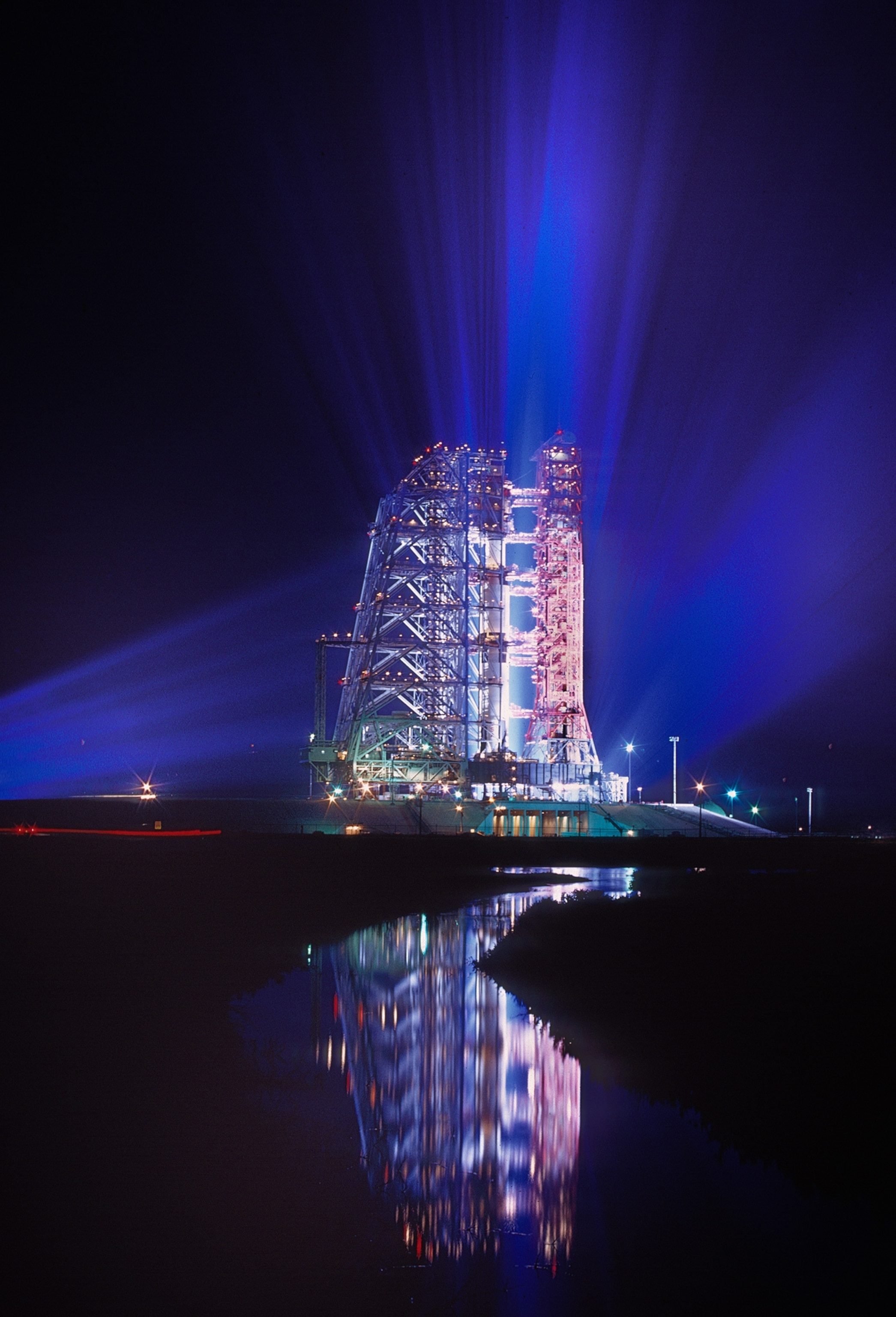 apollo 11 on its launch pad the night before it was launched to the moon.