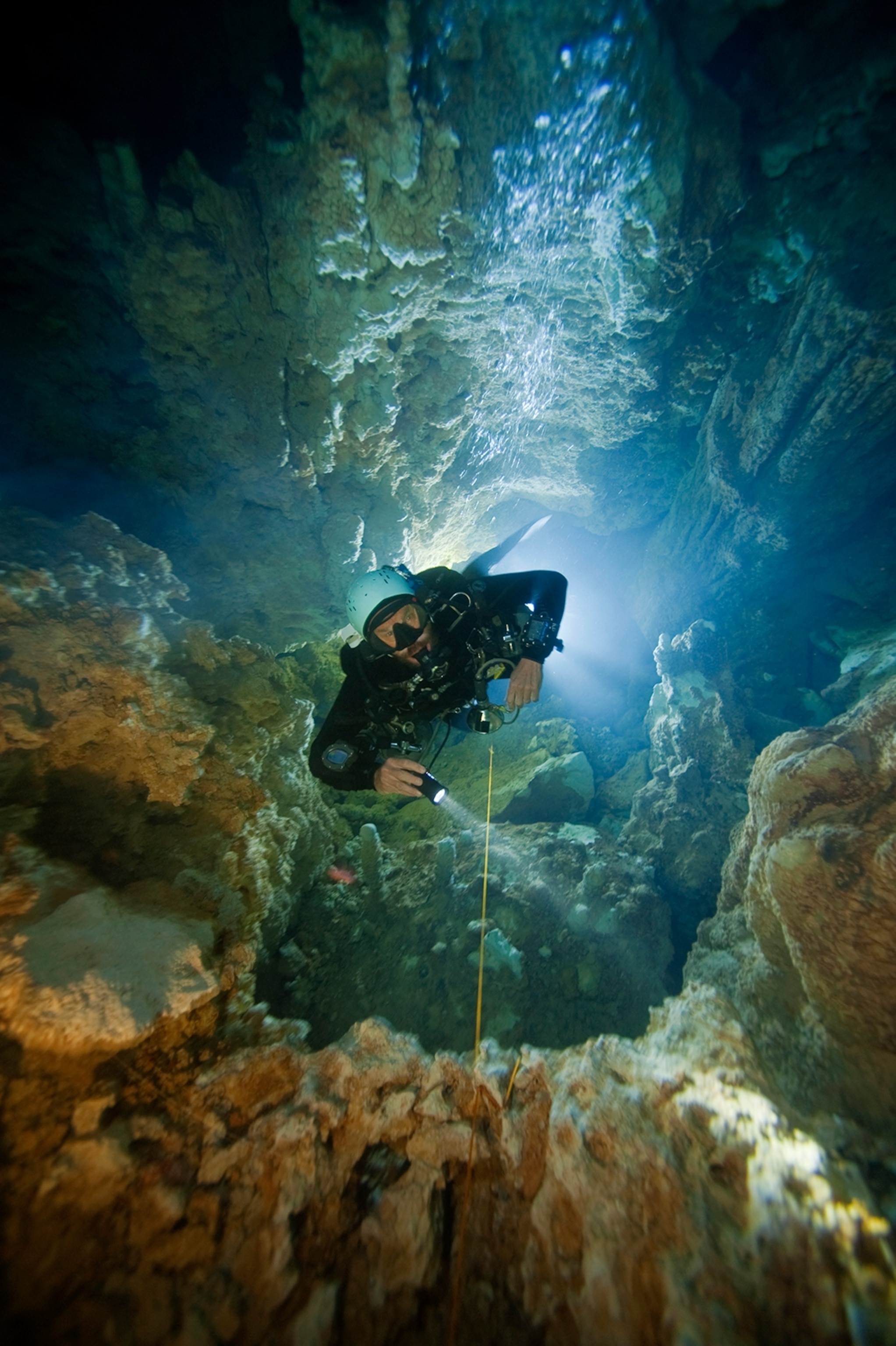 Kenny Broad ascending a deep shaft in Dan's Cave