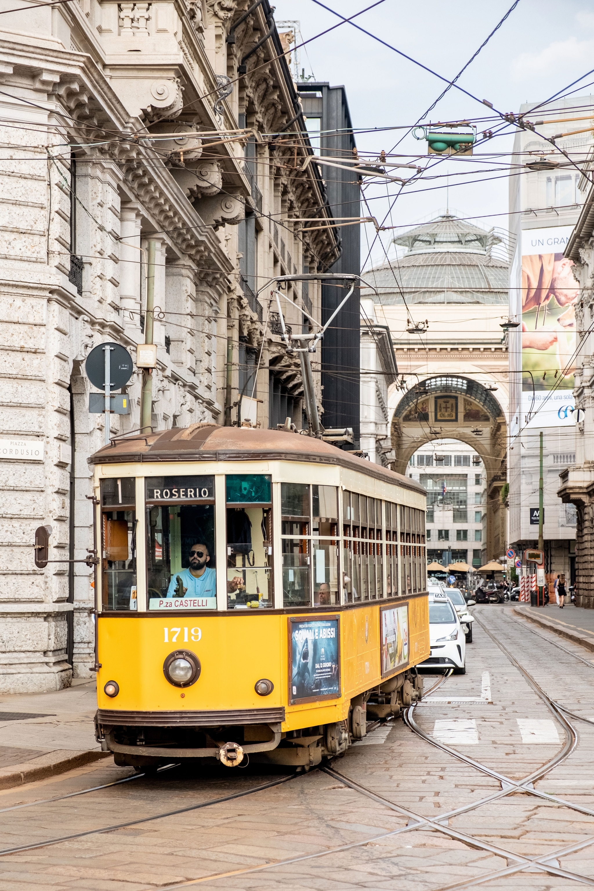 a yellow tram moving within city centre