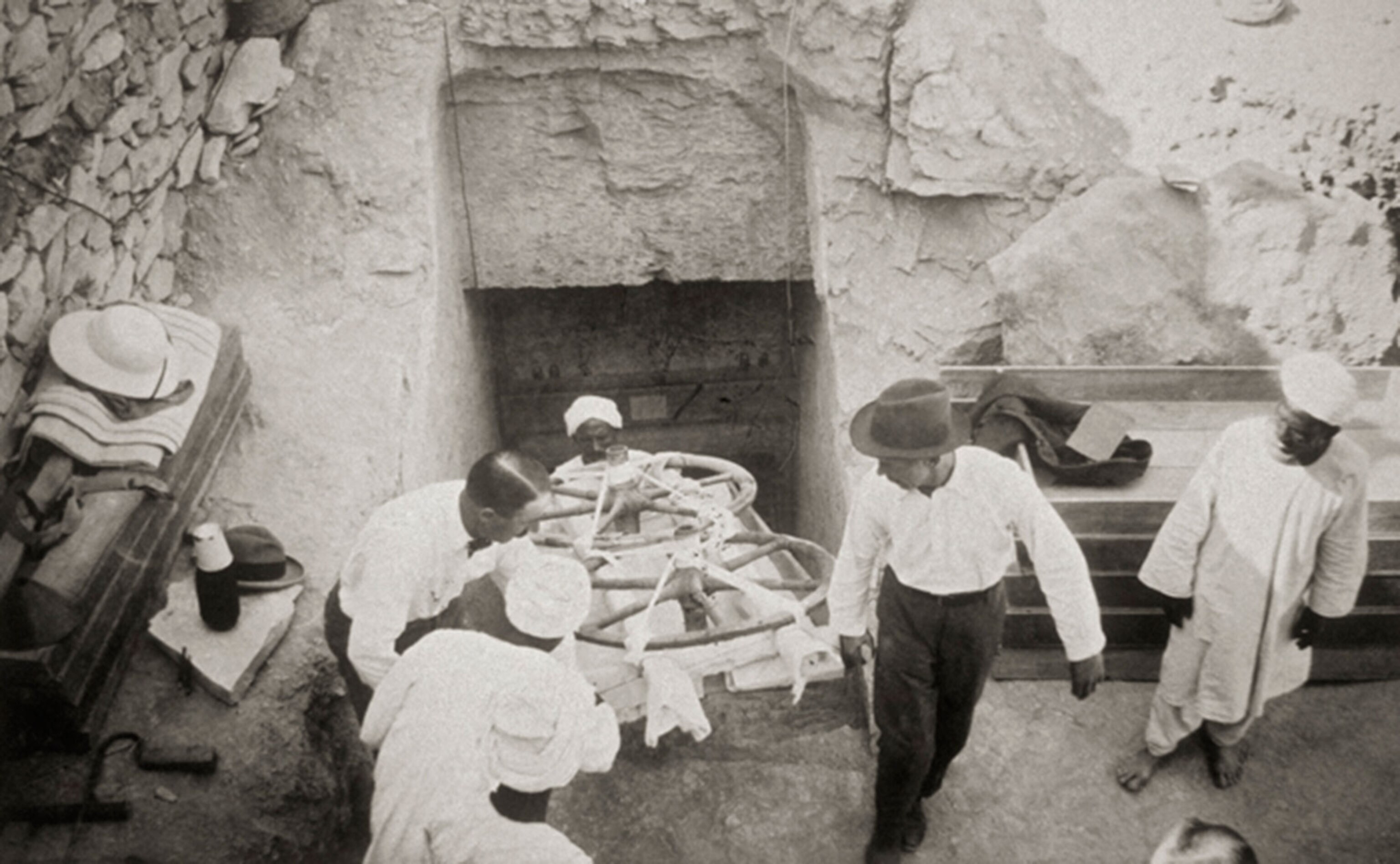 excavators removing wheels of a chariot